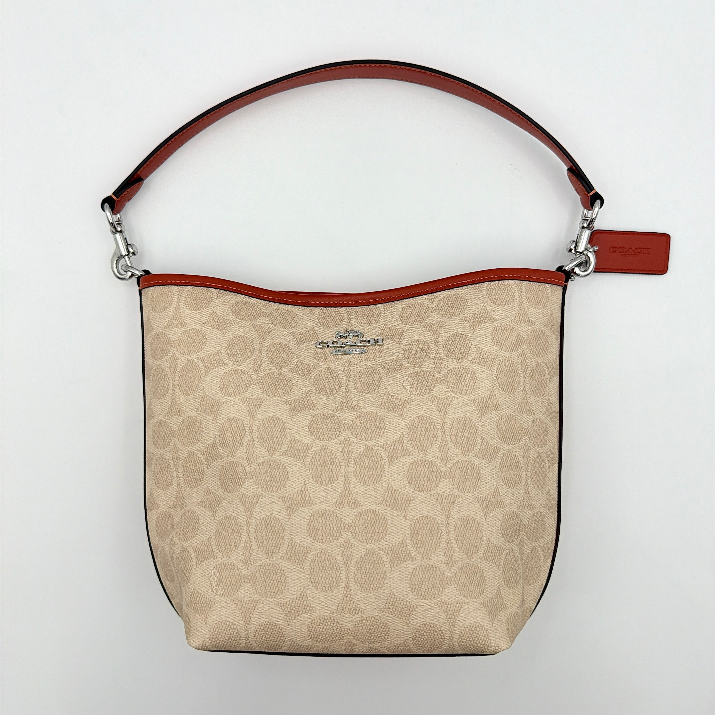 Coach 2Way City Bucket Shoulder Bag in beige signature canvas with red leather accents, detachable strap, and silver-tone hardware.