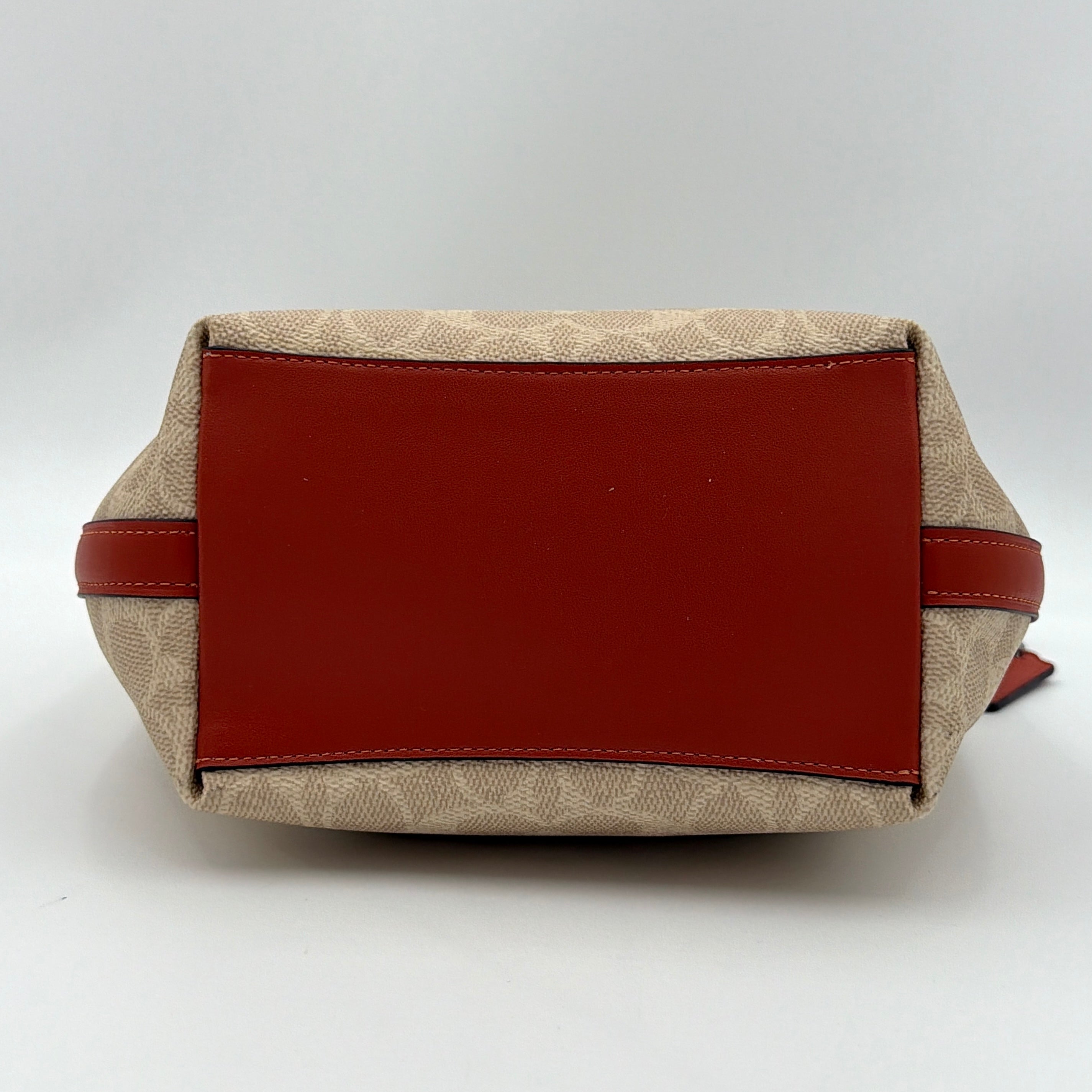 Coach 2Way City Bucket Shoulder Bag in beige signature canvas with red leather accents, detachable strap, and silver-tone hardware.