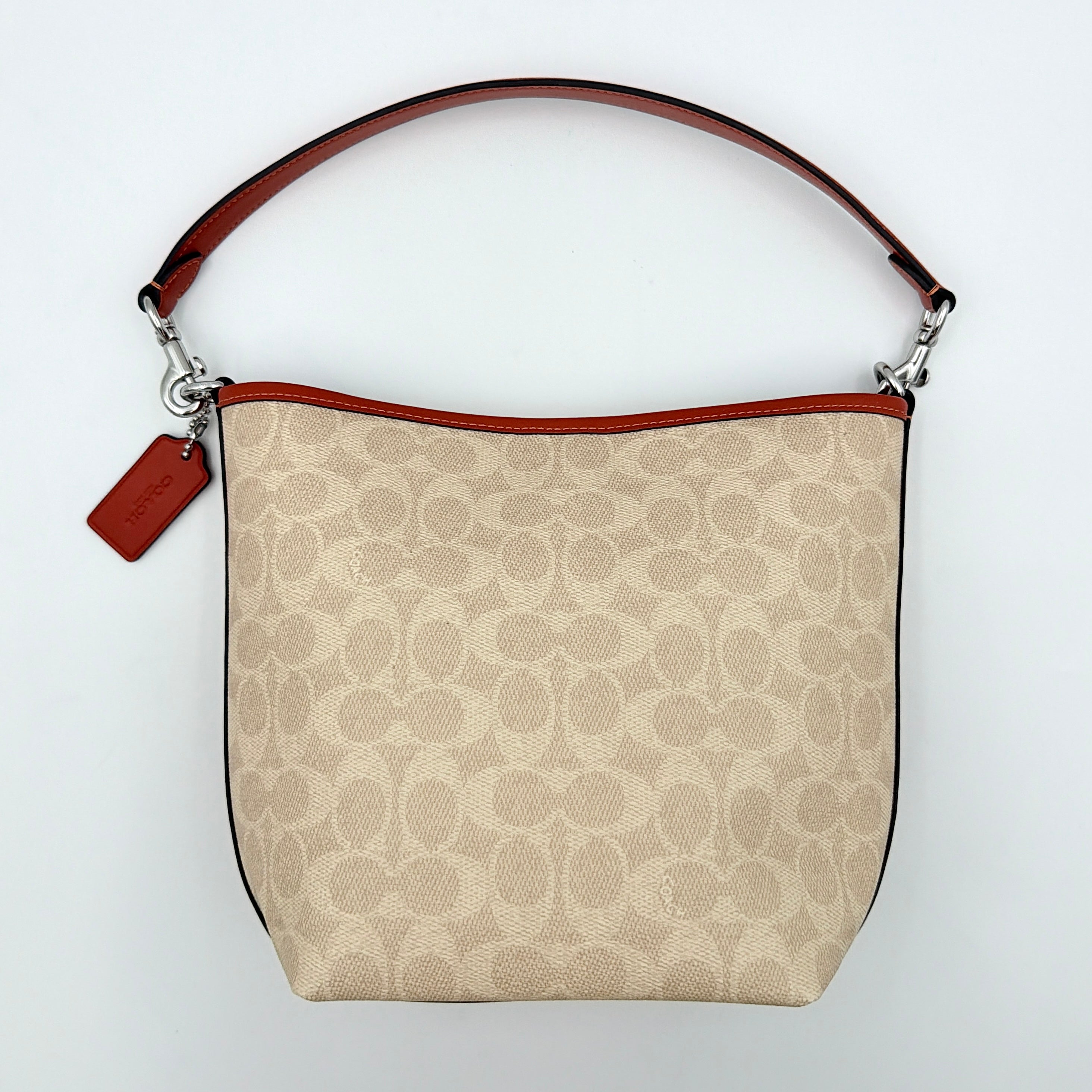 Coach 2Way City Bucket Shoulder Bag in beige signature canvas with red leather accents, detachable strap, and silver-tone hardware.