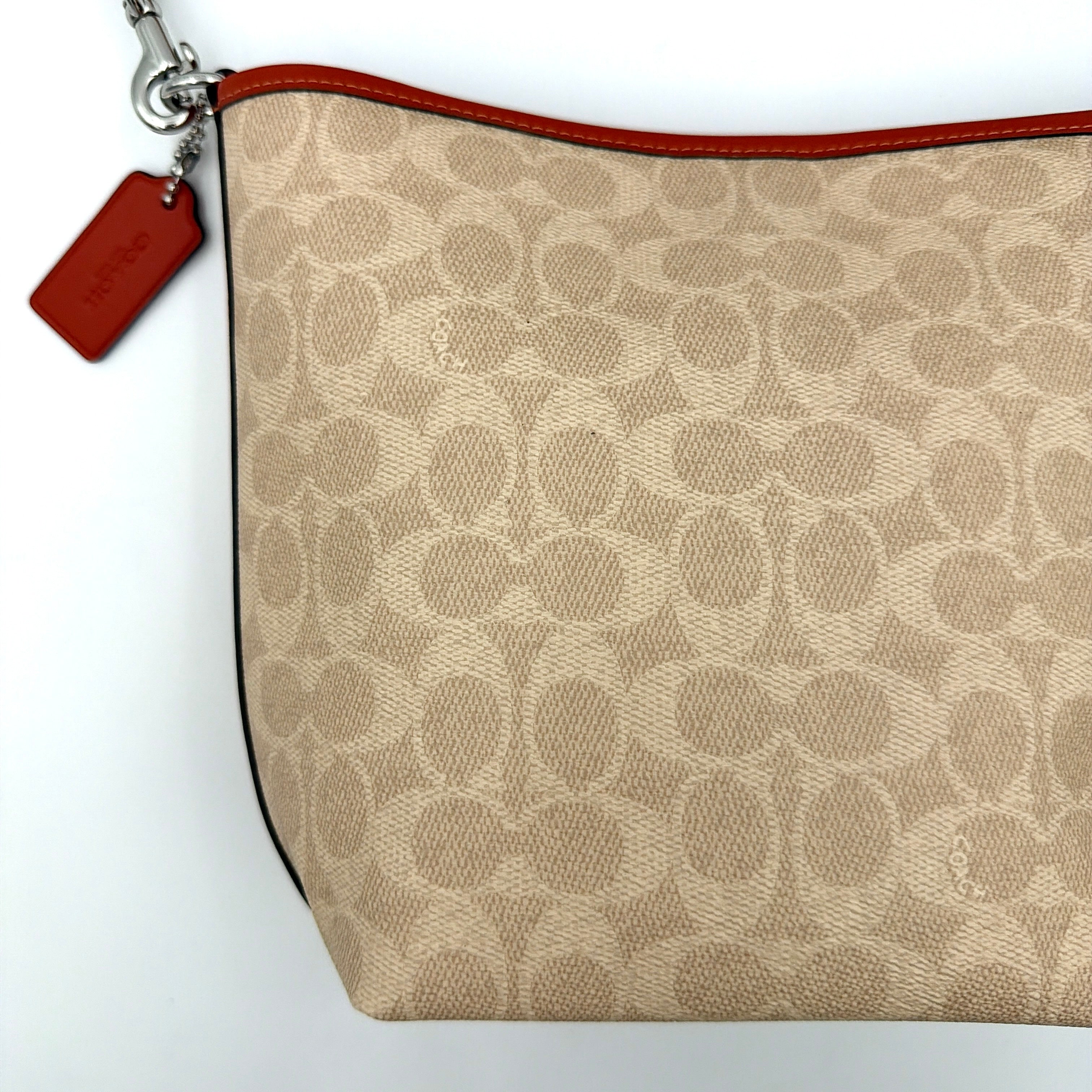 Coach 2Way City Bucket Shoulder Bag in beige signature canvas with red leather accents, detachable strap, and silver-tone hardware.