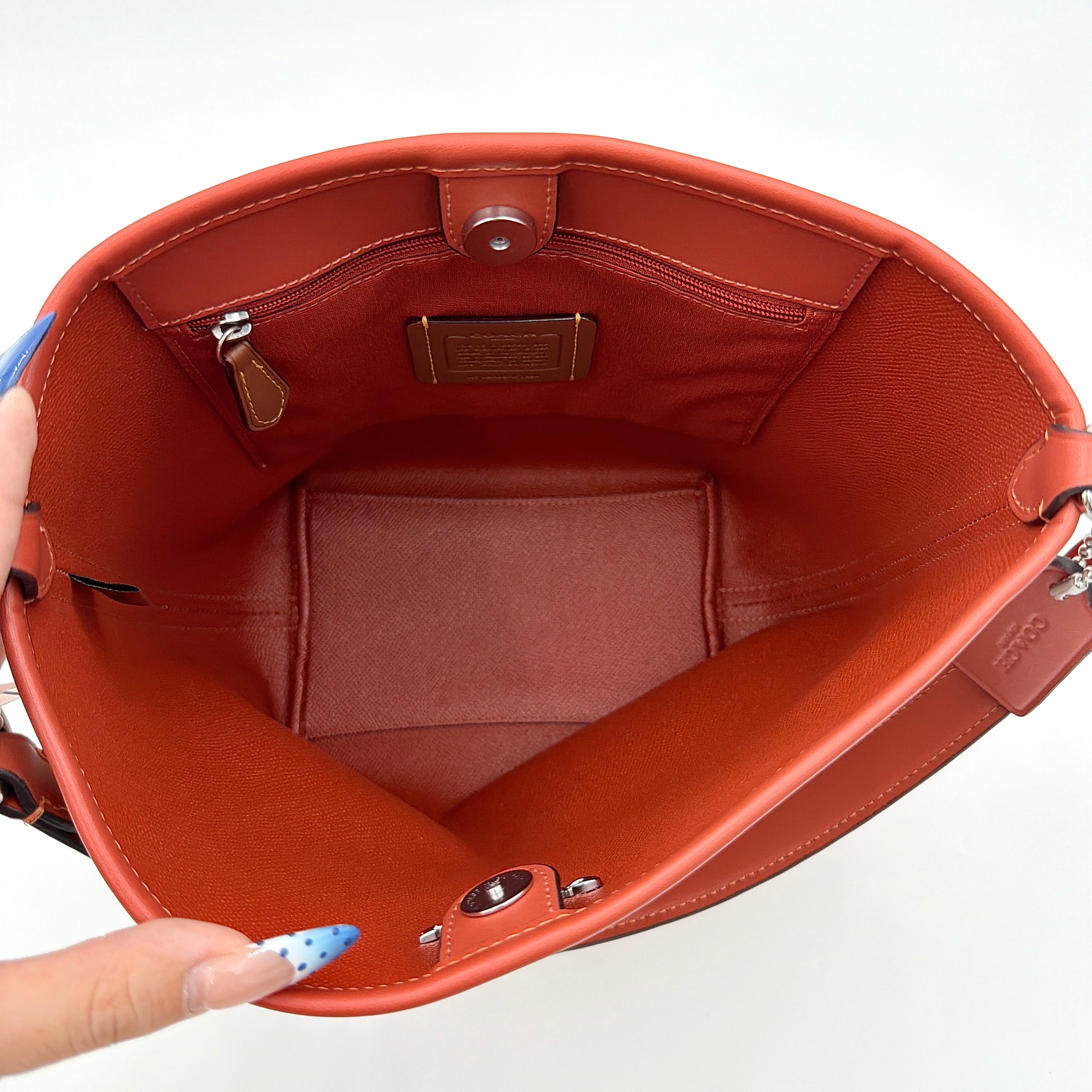 Coach 2Way City Bucket Shoulder Bag in beige signature canvas with red leather accents, detachable strap, and silver-tone hardware.