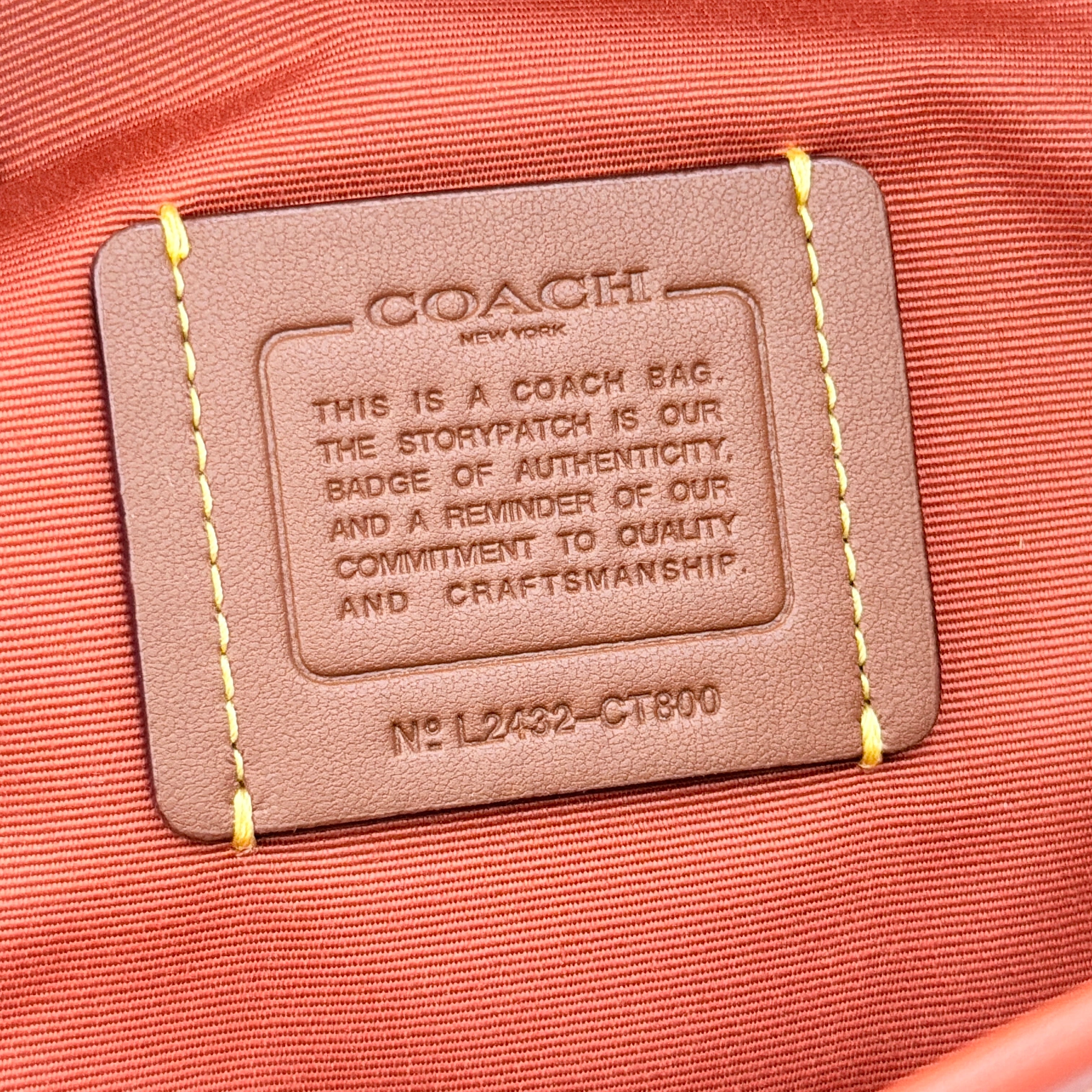Coach 2Way City Bucket Shoulder Bag in beige signature canvas with red leather accents, detachable strap, and silver-tone hardware.
