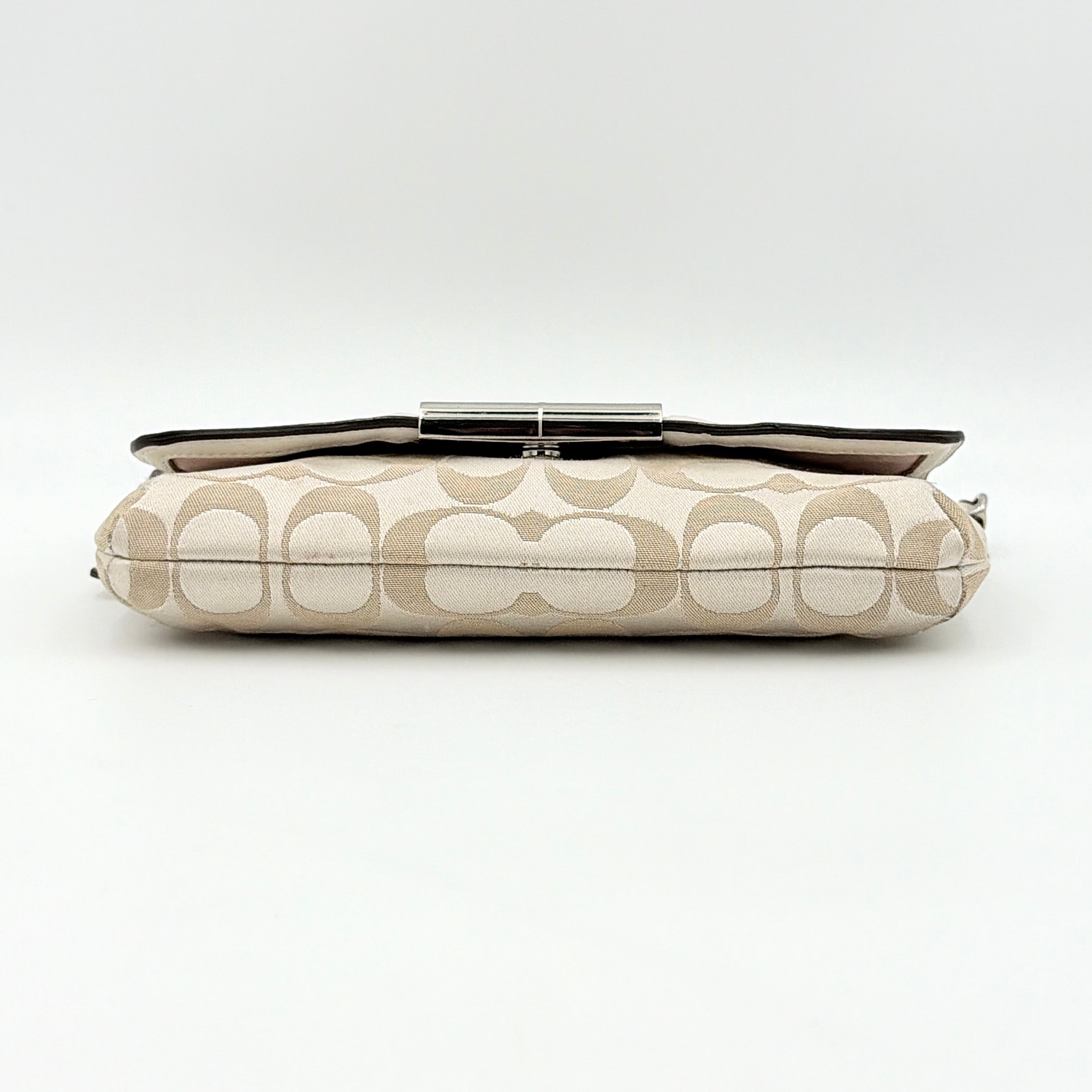 Coach Signature Kristin Shoulder Bag in beige and white jacquard canvas with white leather trim, presented with a polished silver push-lock clasp.
