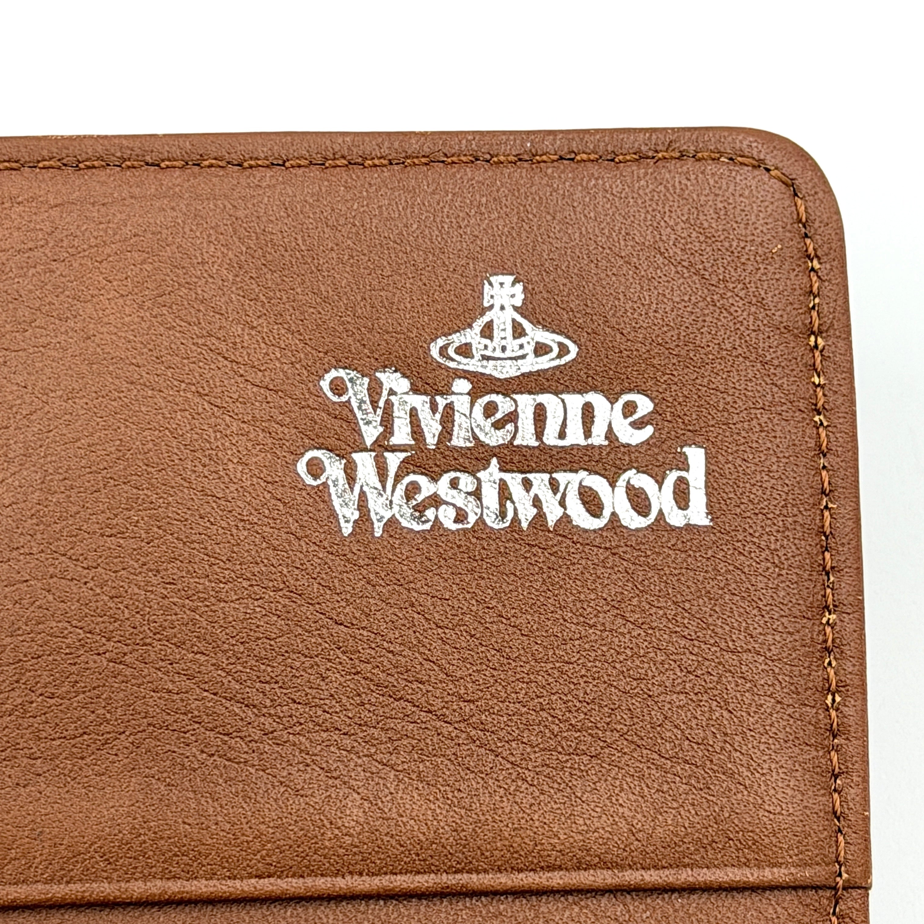 Vivienne Westwood long wallet in chestnut brown leather with white contrast stitching and silver orb embellishment.