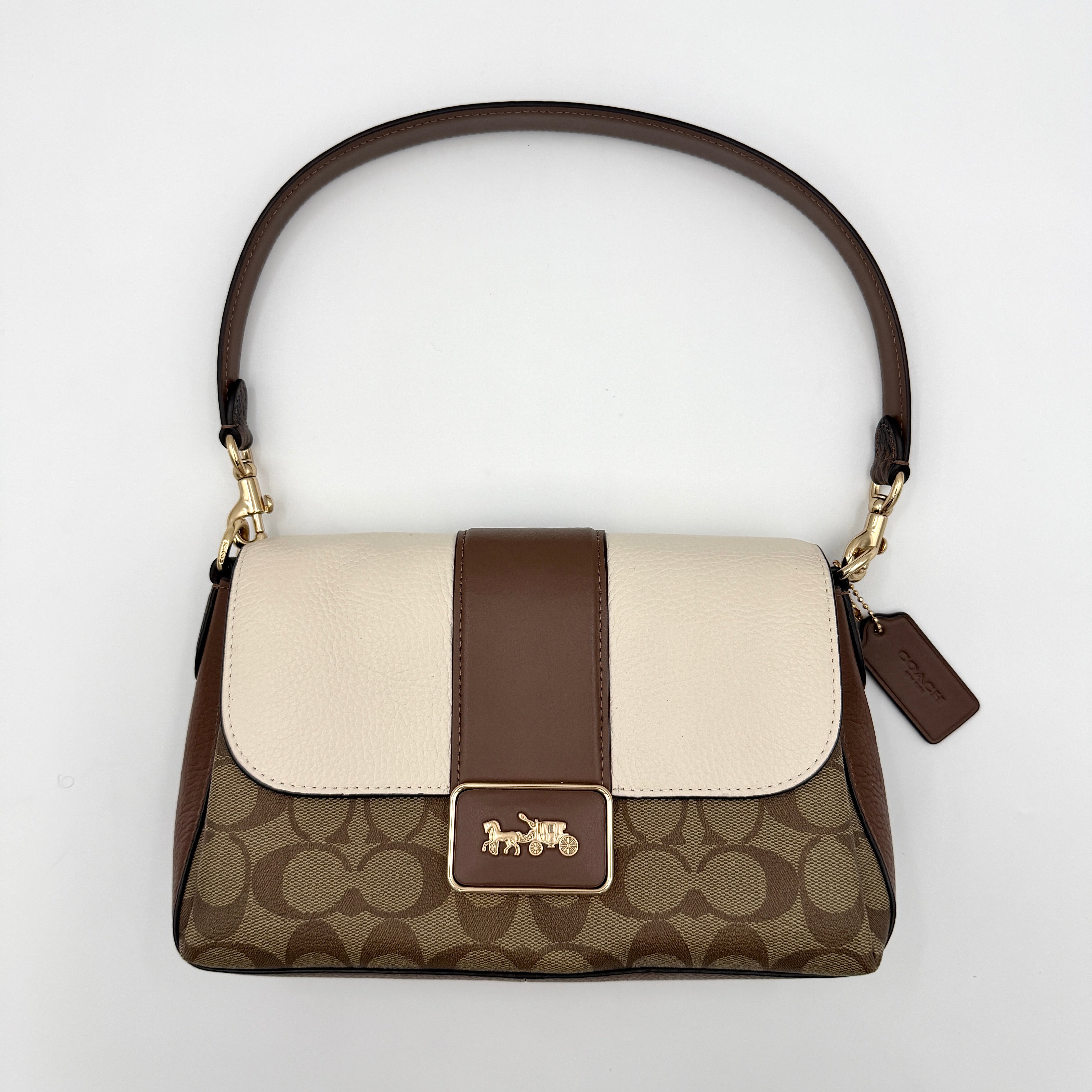 Coach Signature Grace Shoulder Bag in beige and white leather with monogram canvas and gold hardware, displayed with structured silhouette and top handle.