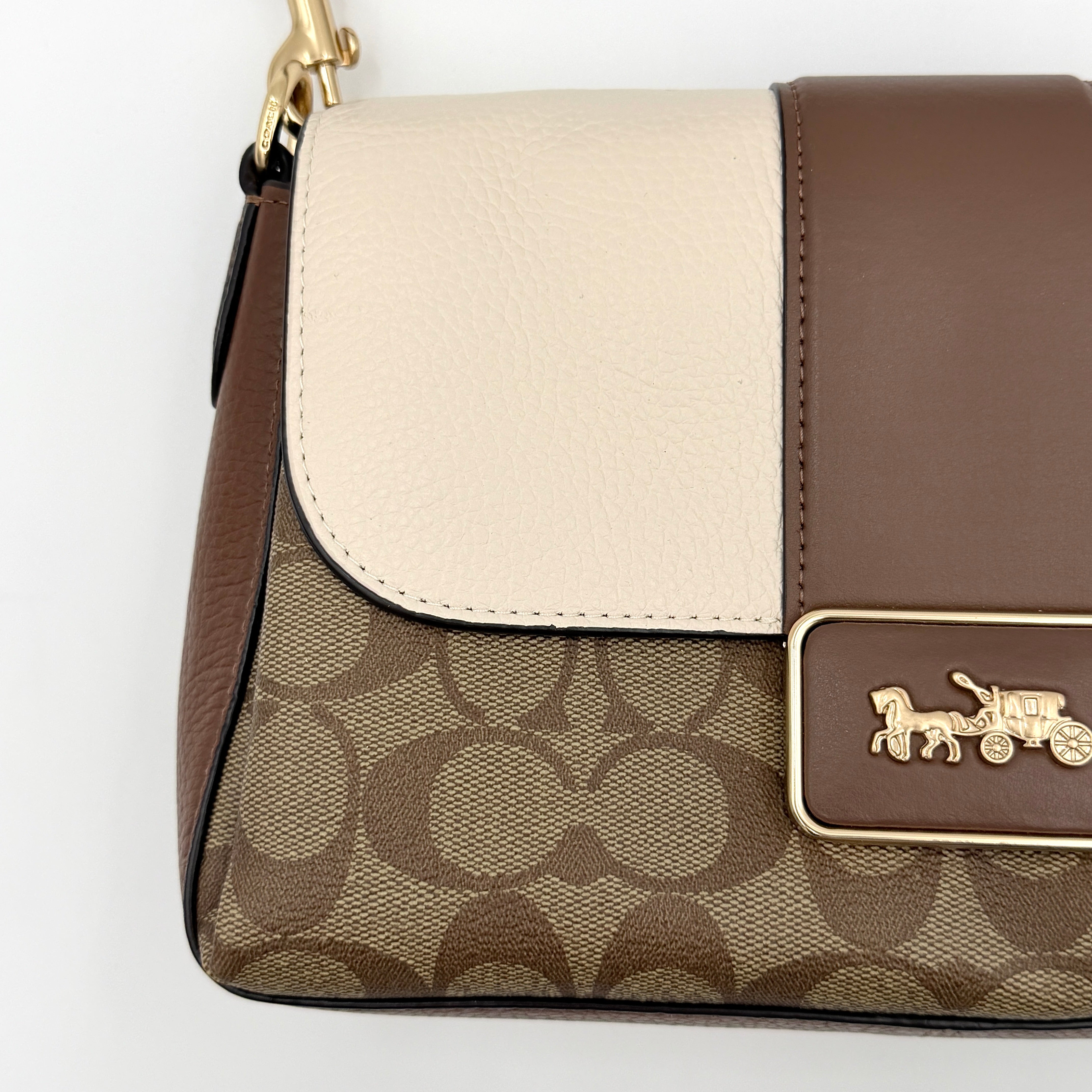 Coach Signature Grace Shoulder Bag in beige and white leather with monogram canvas and gold hardware, displayed with structured silhouette and top handle.