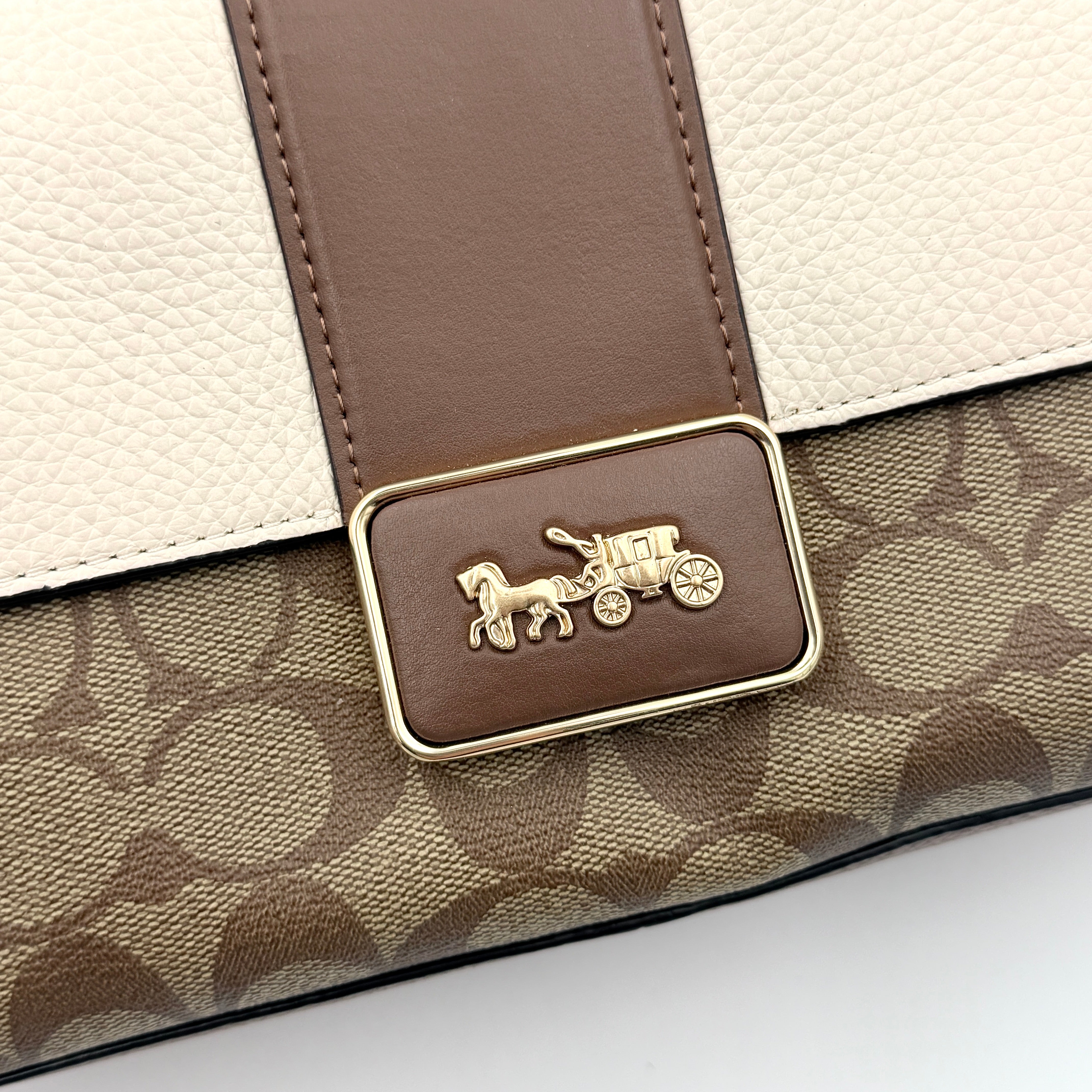 Coach Signature Grace Shoulder Bag in beige and white leather with monogram canvas and gold hardware, displayed with structured silhouette and top handle.
