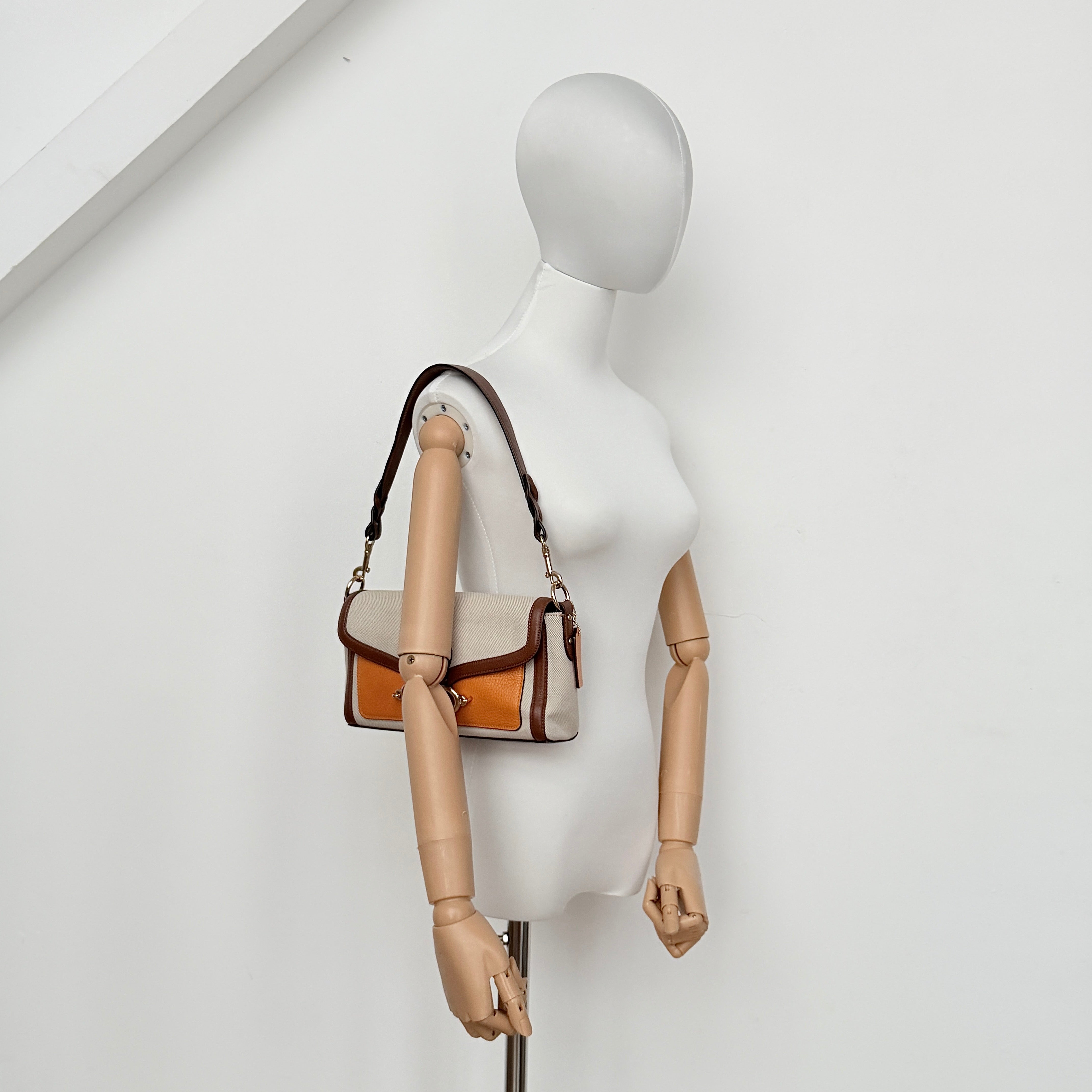 Coach Jade 2Way Shoulder Bag in sand canvas with amber and brown leather trim, gold-tone carriage hardware, and detachable strap.
