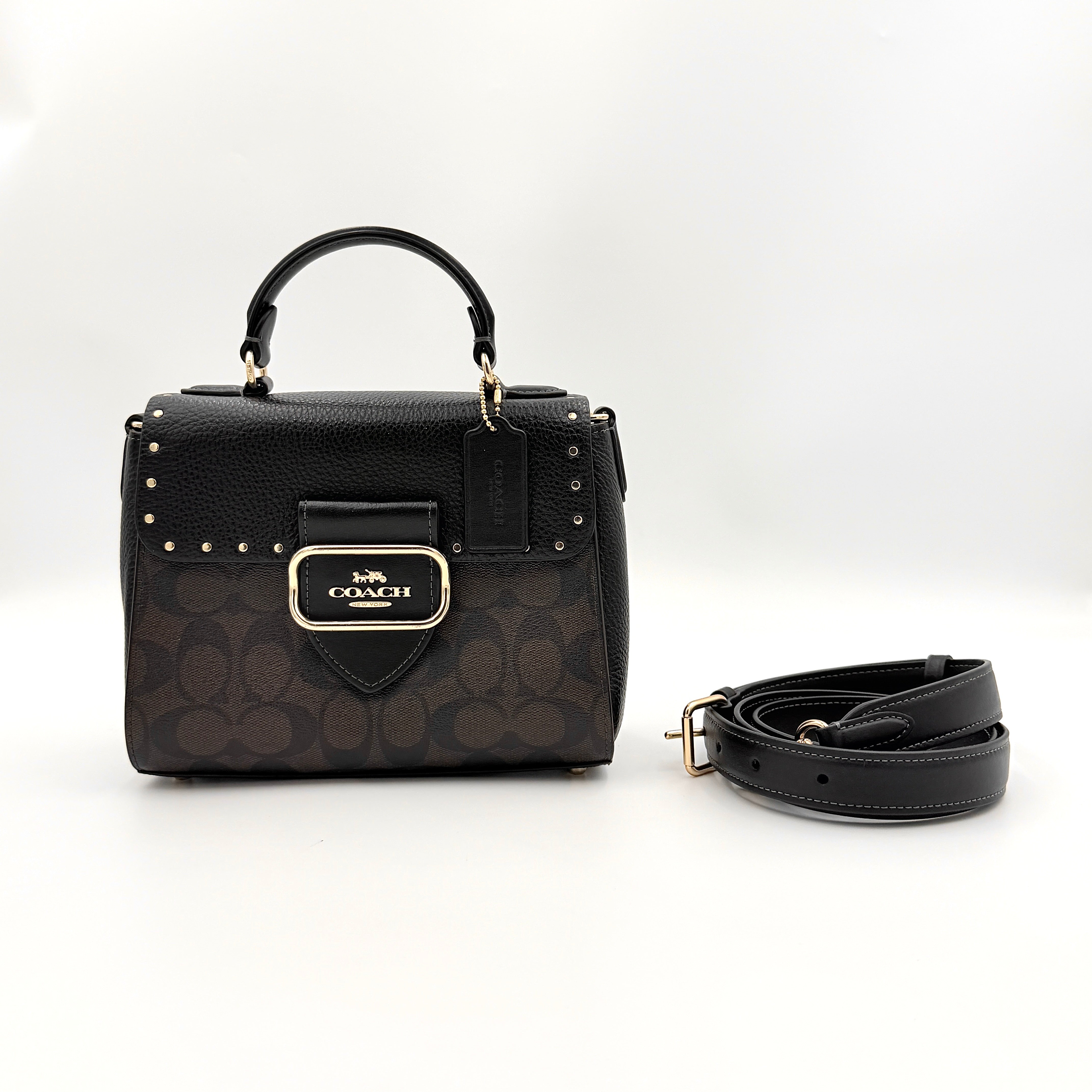 Coach Morgan Top Handle Bag in brown and black signature canvas with pebbled leather, gold hardware and detachable strap displayed alongside a Coach dustbag.
