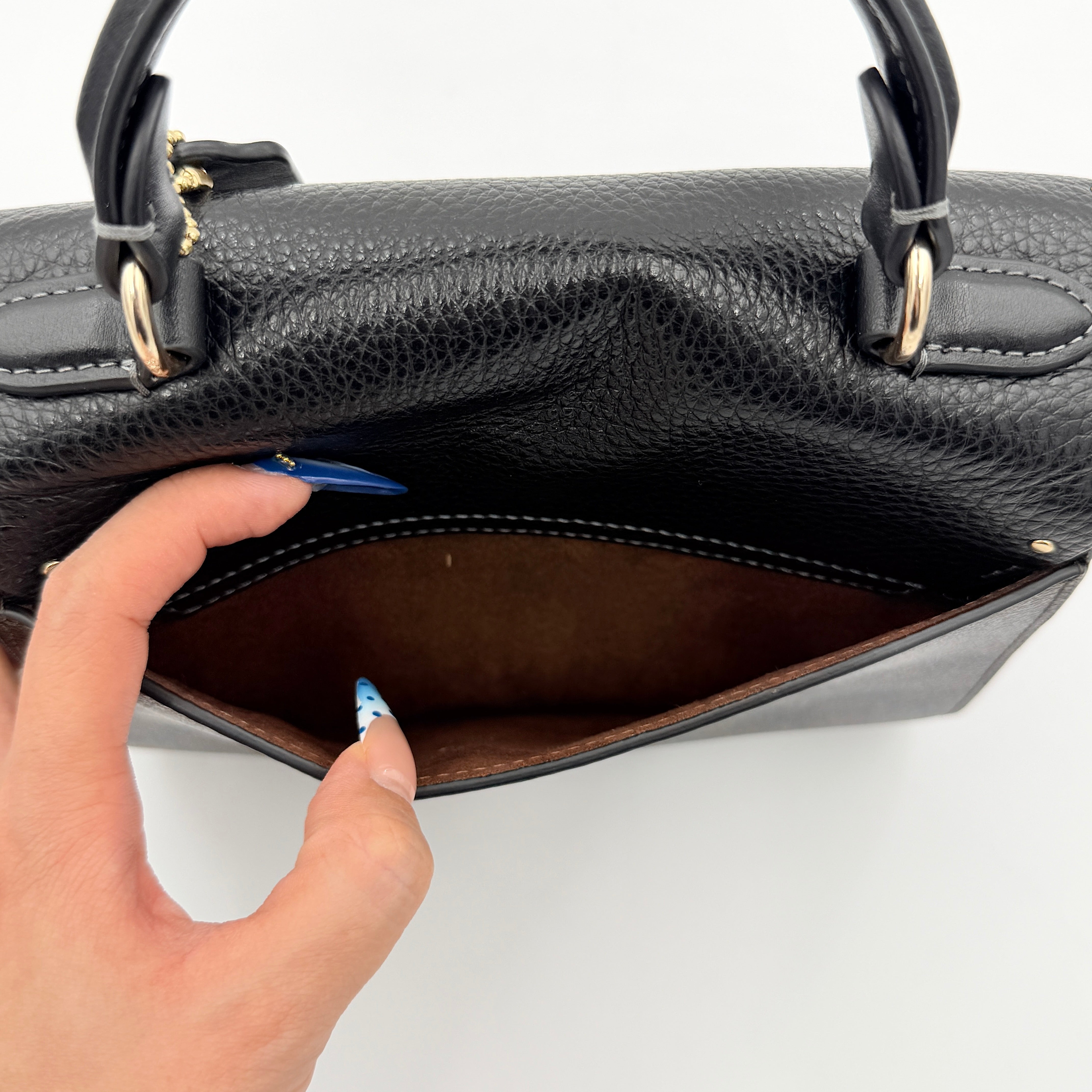 Coach Morgan Top Handle Bag in brown and black signature canvas with pebbled leather, gold hardware and detachable strap displayed alongside a Coach dustbag.