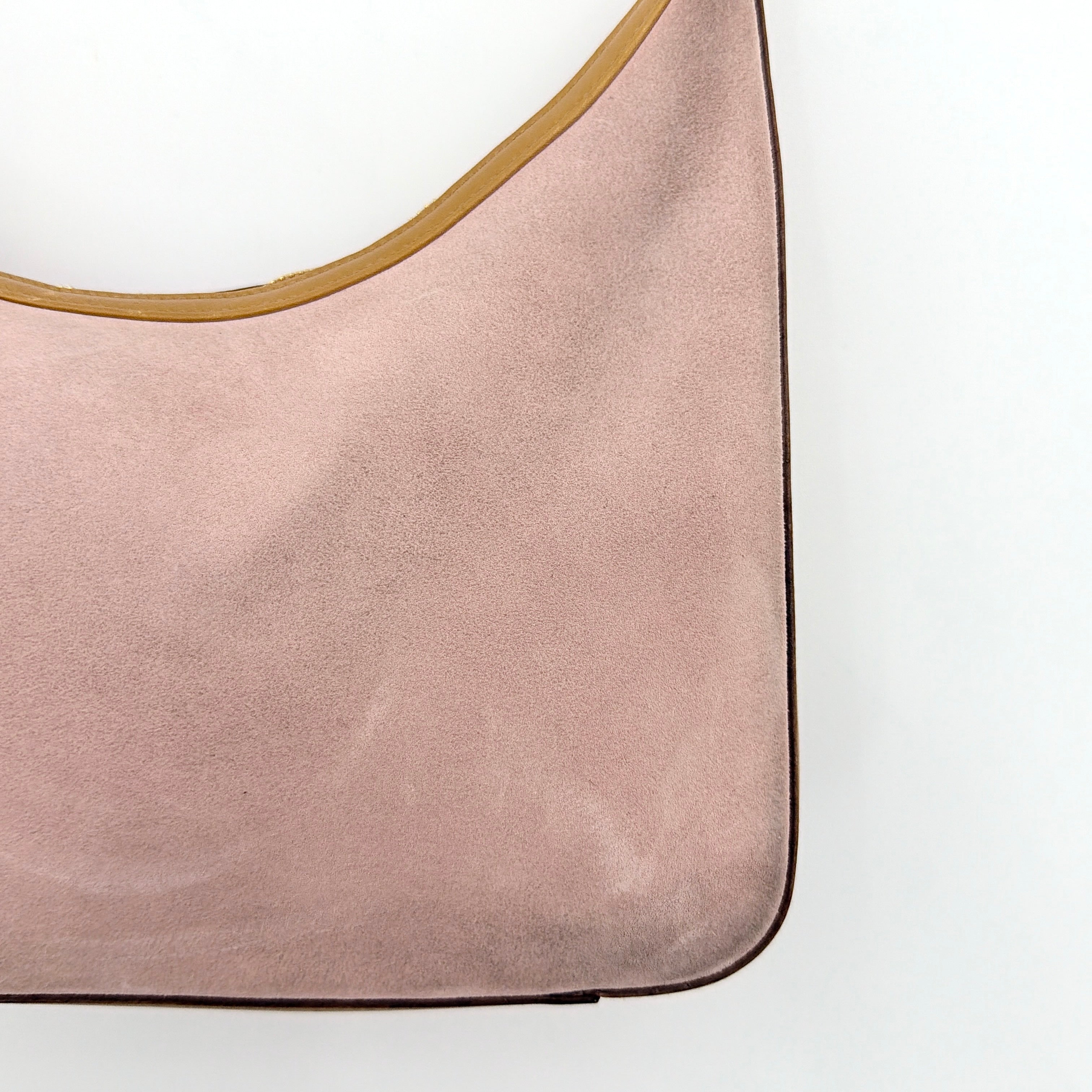Gucci hobo shoulder bag in blush pink suede with tan leather trim and gold hardware, displayed against a white background.