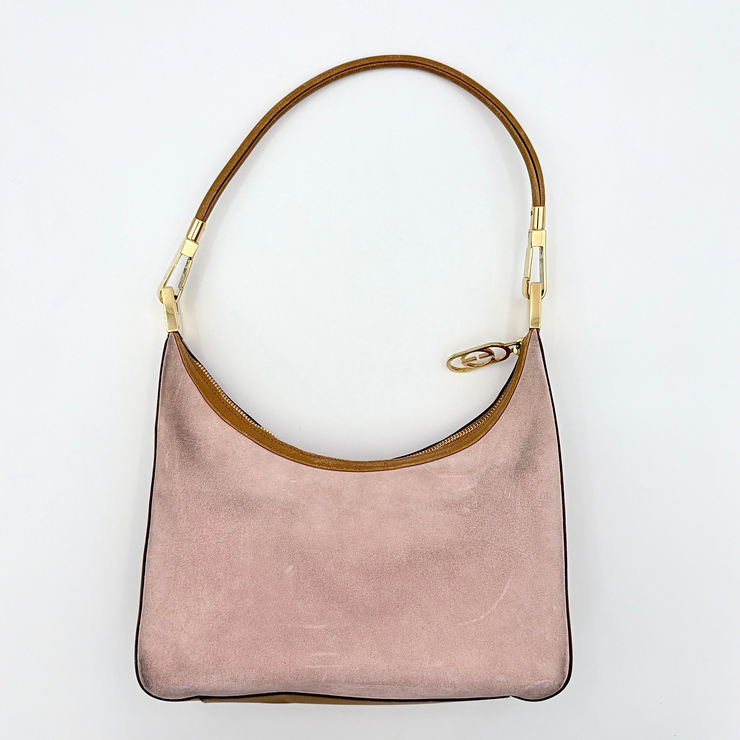 Gucci hobo shoulder bag in blush pink suede with tan leather trim and gold hardware, displayed against a white background.