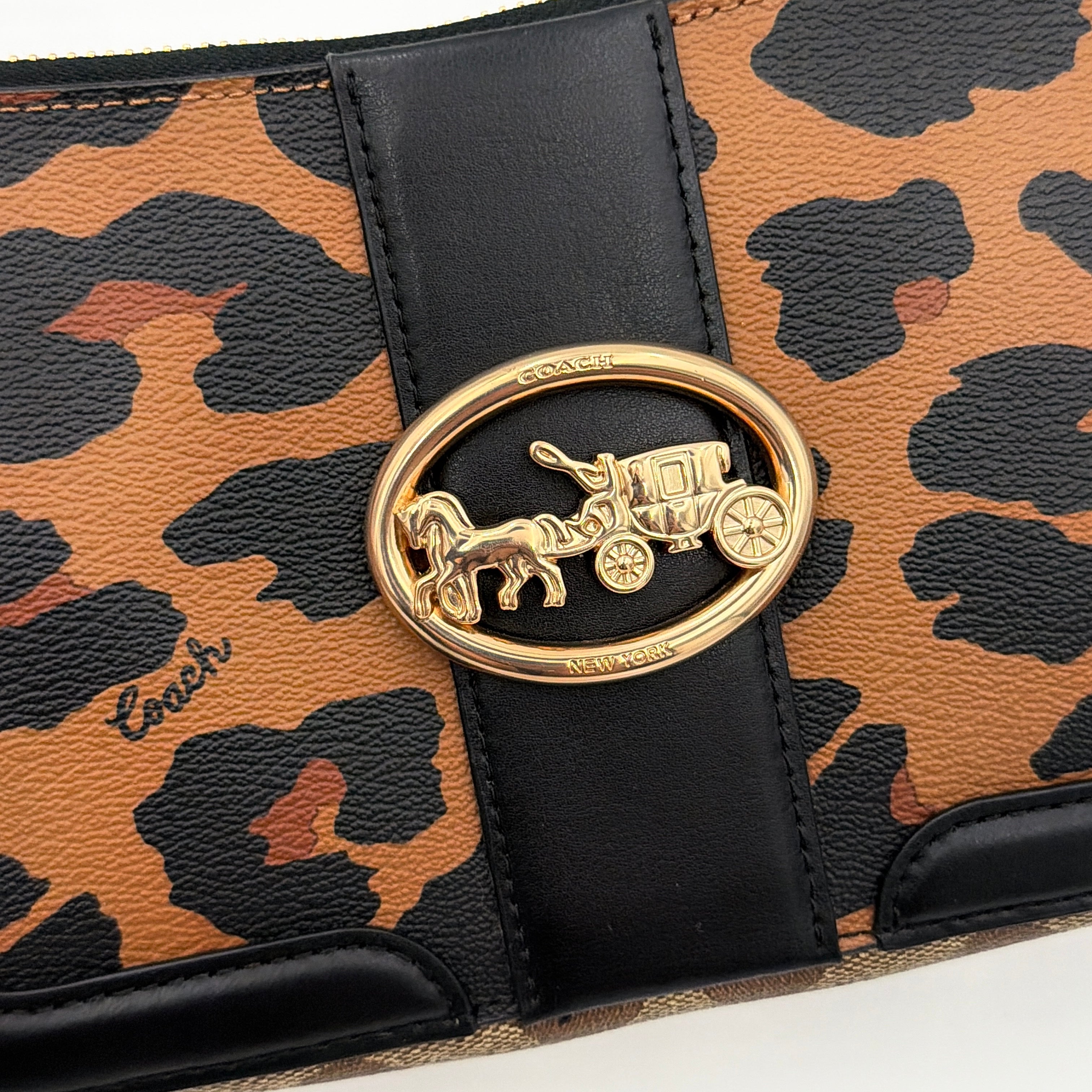 Coach Georgie Shoulder Bag in brown and black leopard print with gold horse and carriage medallion, displayed with its detachable chain and leather strap.