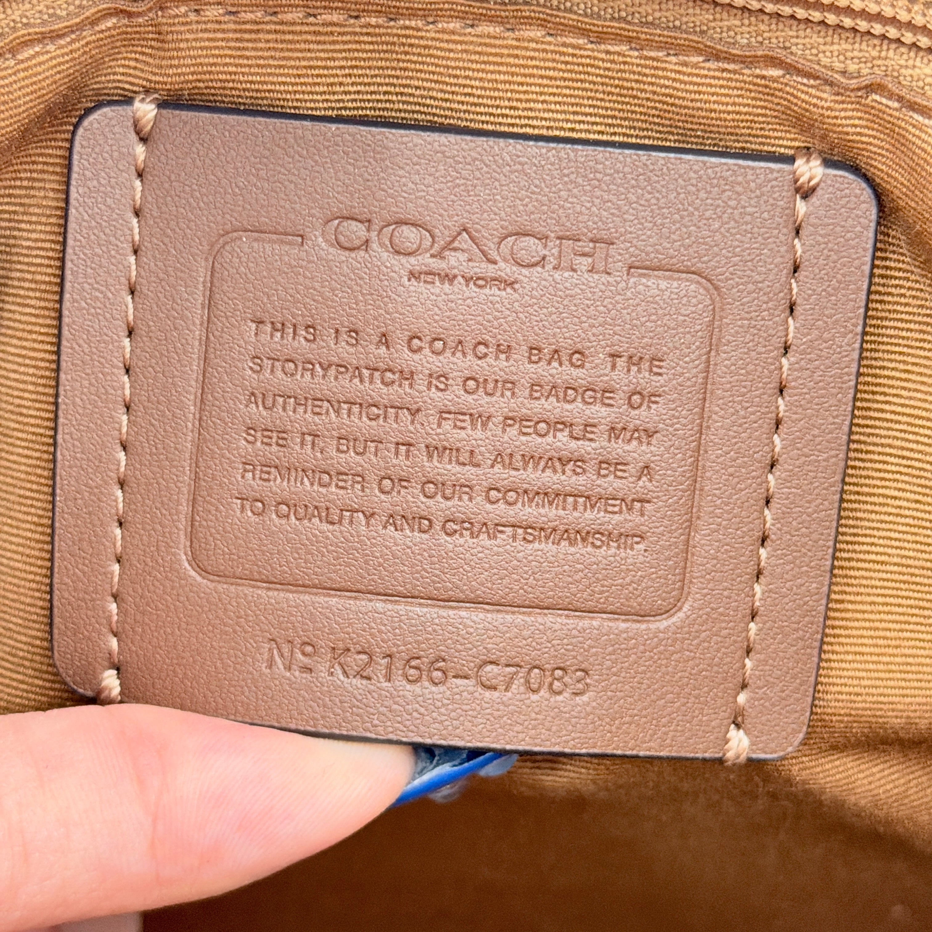 Coach Signature Dempsey 22 Stripe Tote Bag in beige canvas with bold vertical stripes, leather trims, logo patch, and detachable strap.