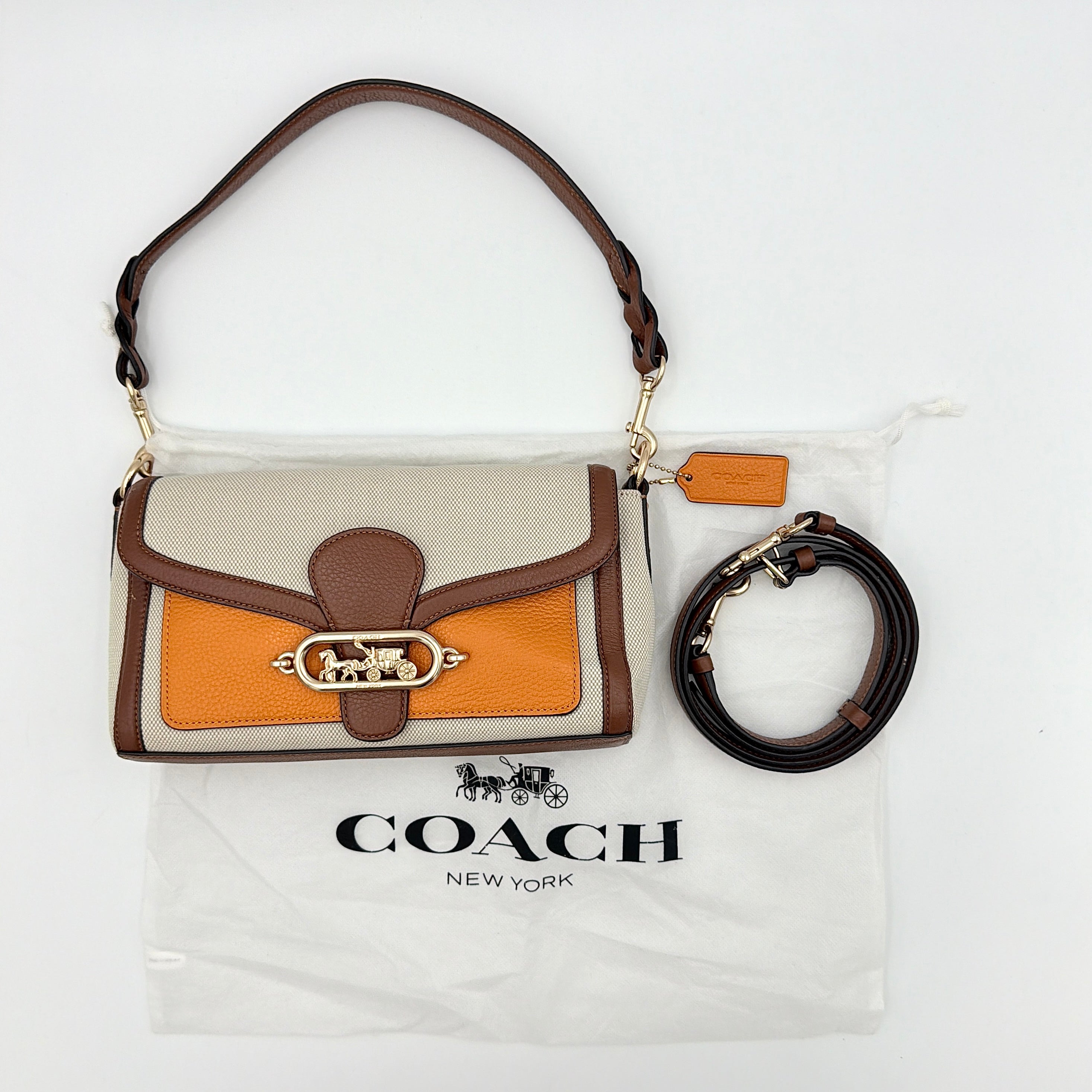 Coach Jade 2Way Shoulder Bag in sand canvas with amber and brown leather trim, gold-tone carriage hardware, and detachable strap.