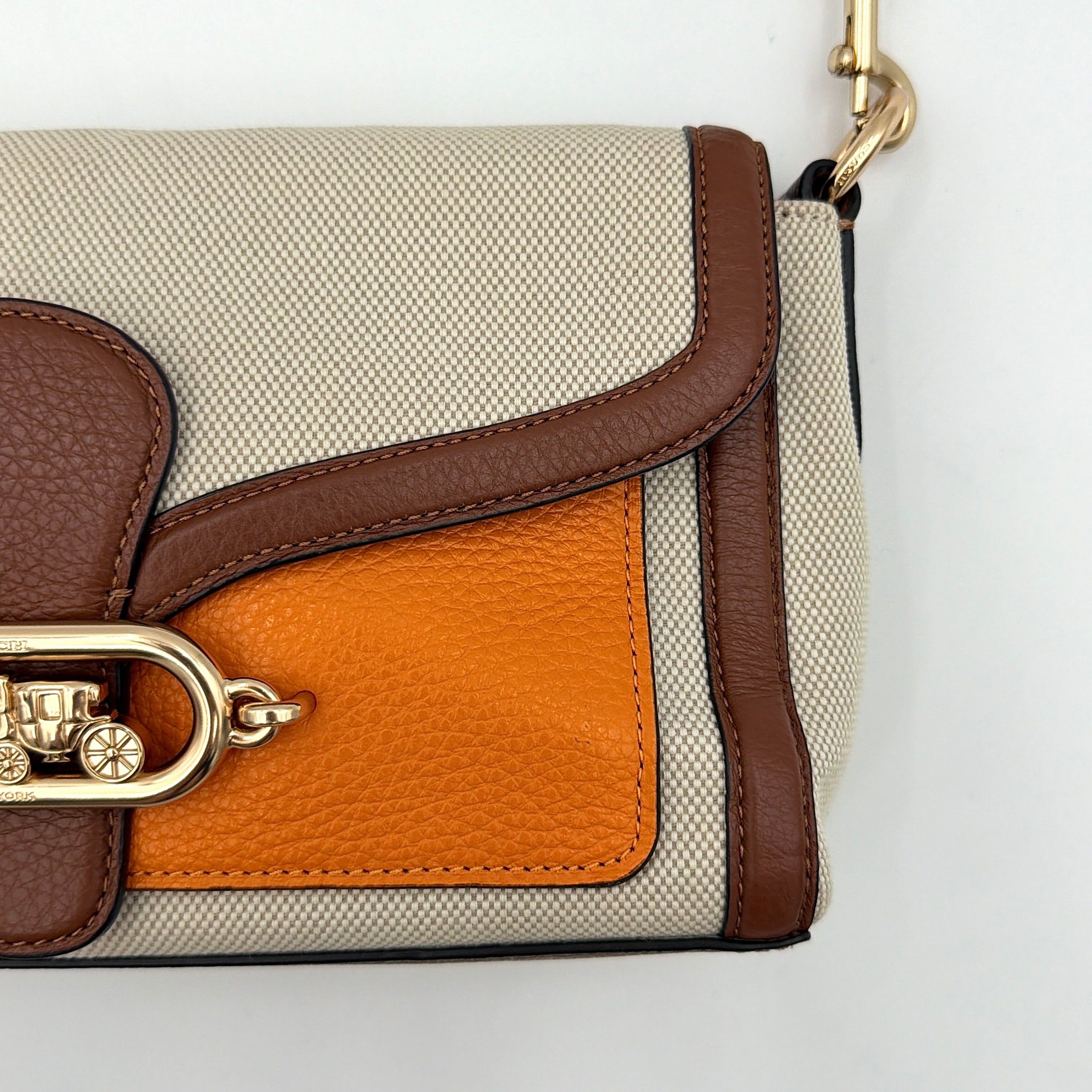 Coach Jade 2Way Shoulder Bag in sand canvas with amber and brown leather trim, gold-tone carriage hardware, and detachable strap.