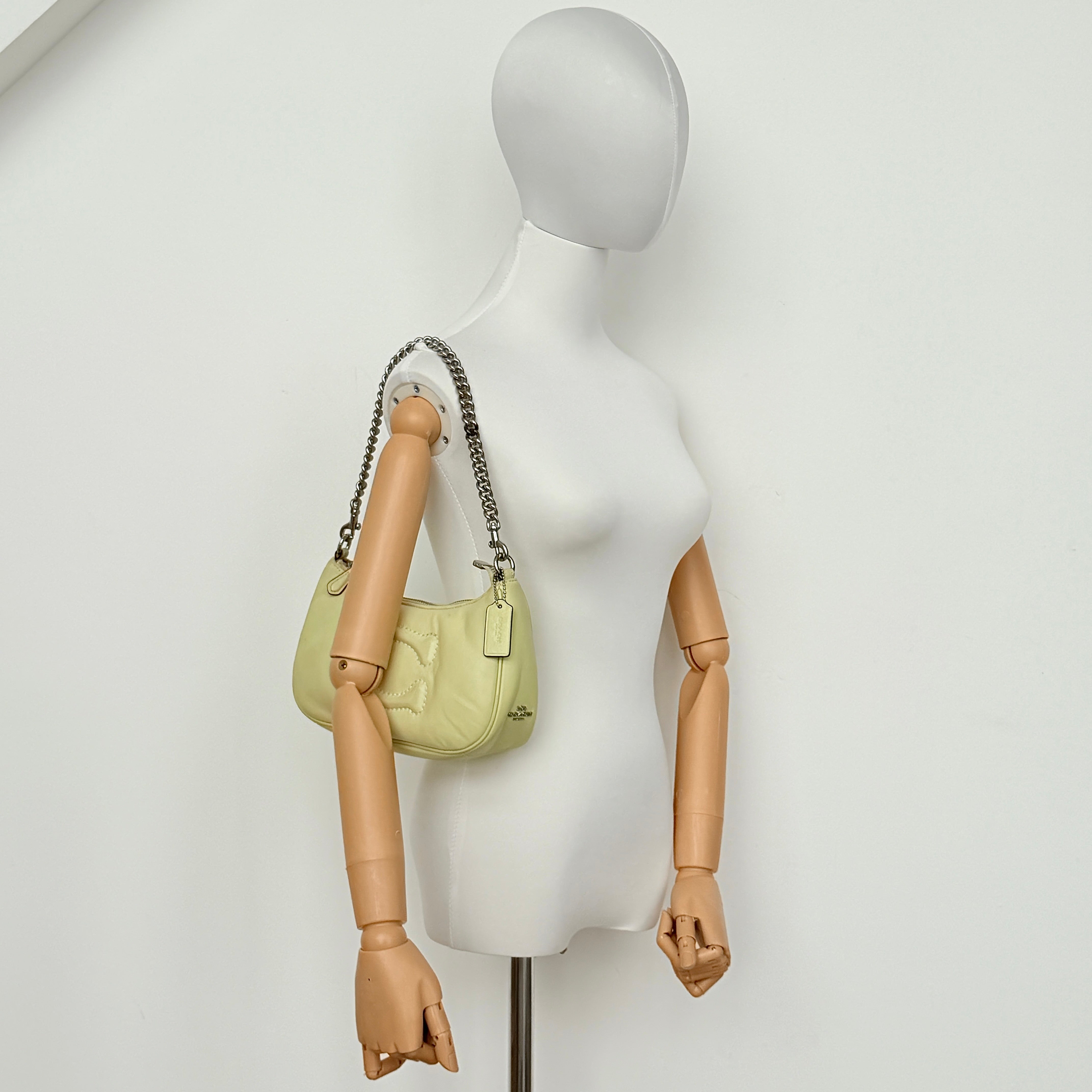 Coach 2Way C Teri Quilted Shoulder Bag in pastel green leather with oversized chain handle and detachable strap, displayed against a clean background.