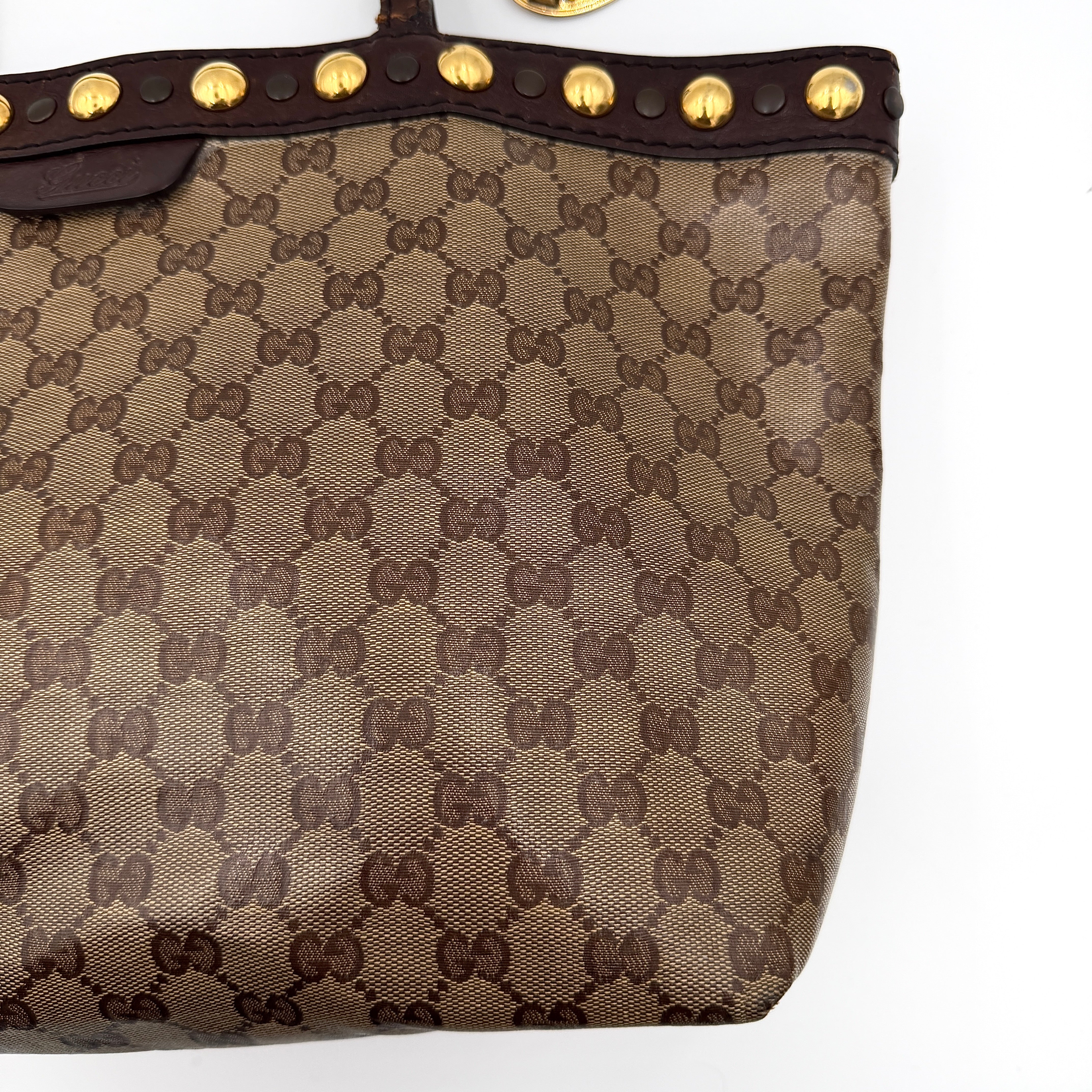 Gucci Babouska shoulder bag in GG monogram crystal canvas with gold-tone stud details and brown leather trim.
