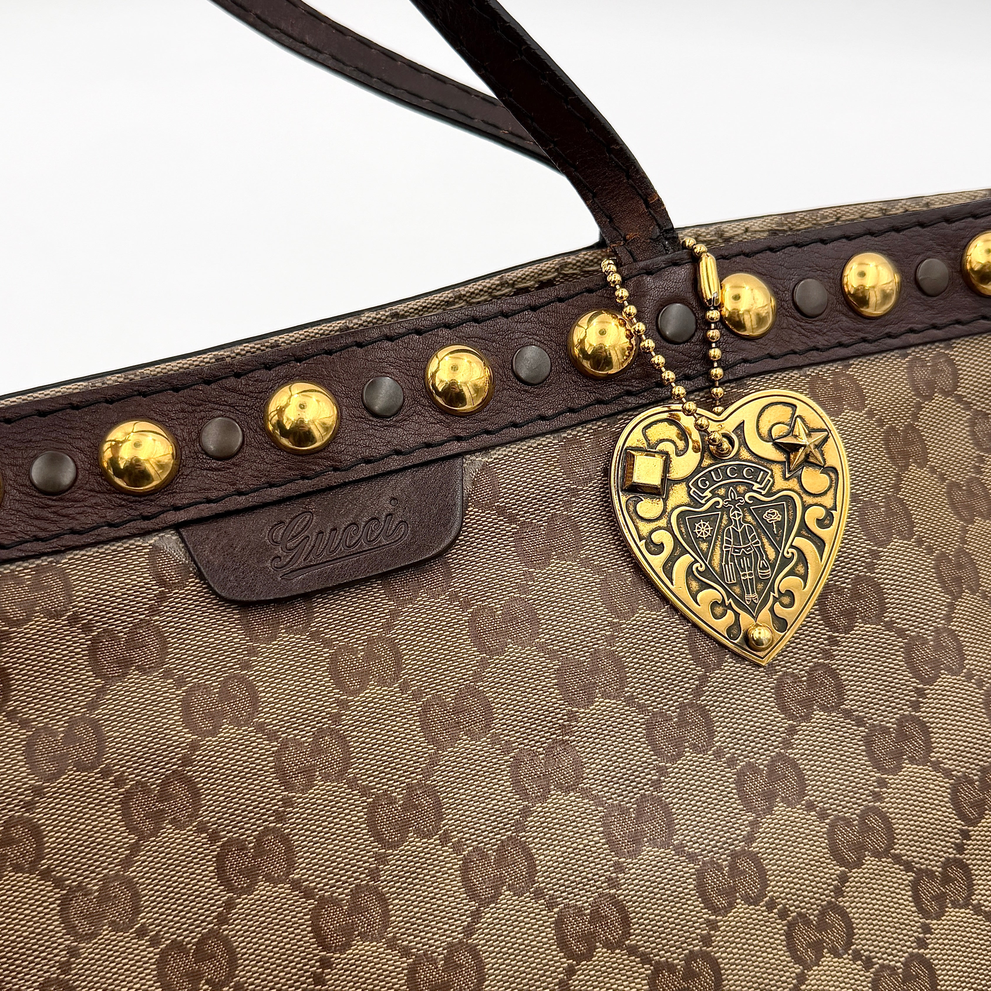 Gucci Babouska shoulder bag in GG monogram crystal canvas with gold-tone stud details and brown leather trim.