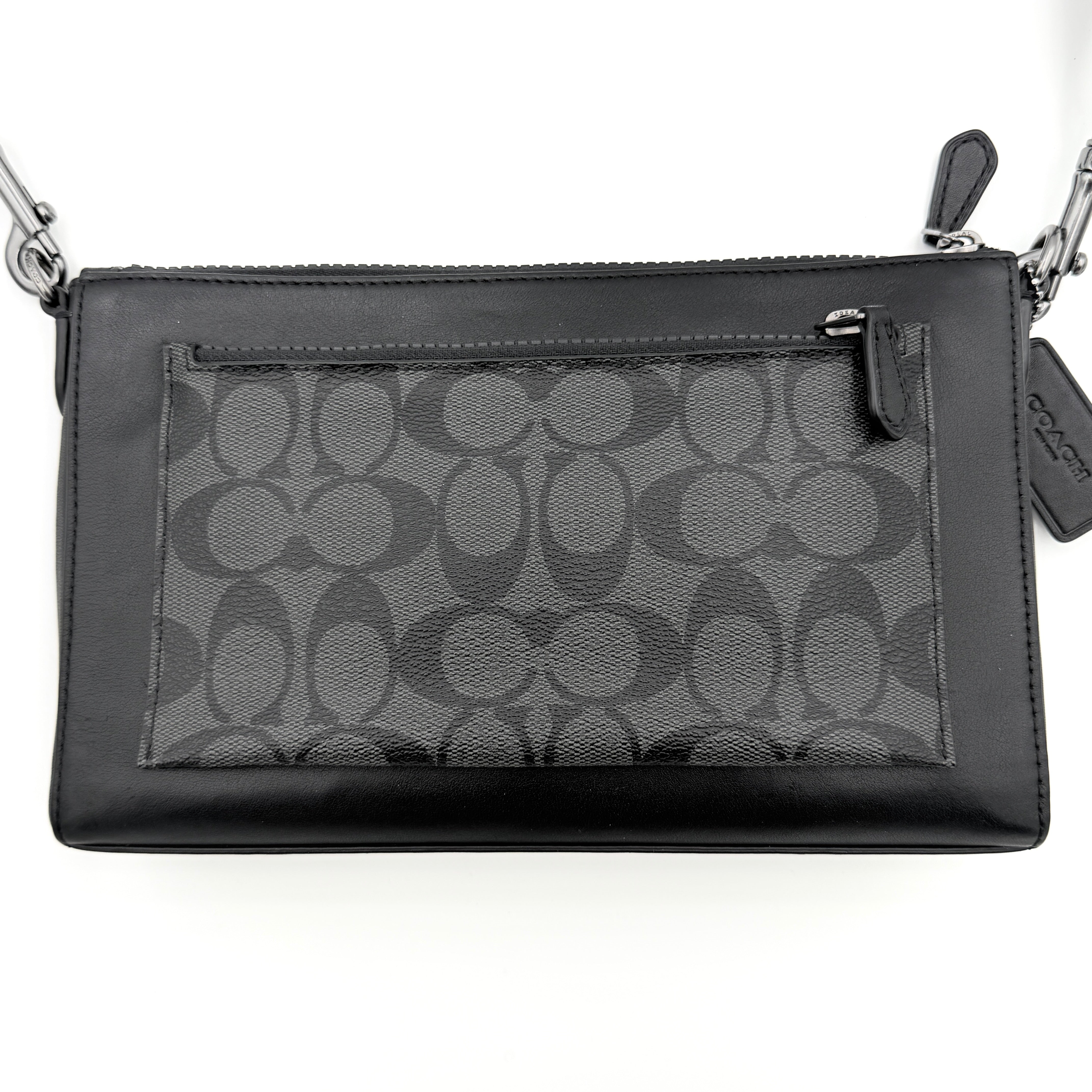 Coach Signature Holden Crossbody Bag in black with beige round coin pouch, featuring coated canvas and leather panels against a white background.