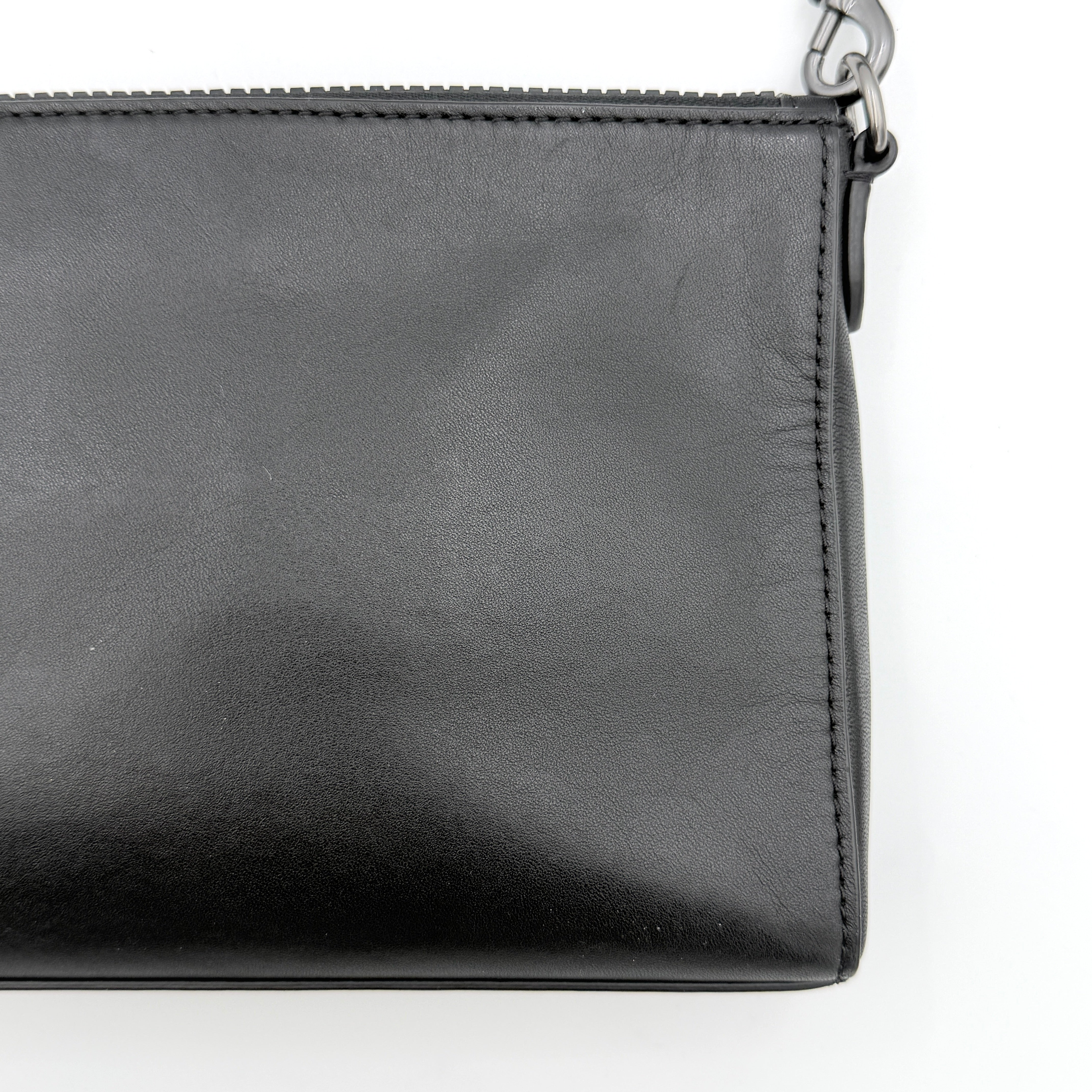 Coach Signature Holden Crossbody Bag in black with beige round coin pouch, featuring coated canvas and leather panels against a white background.