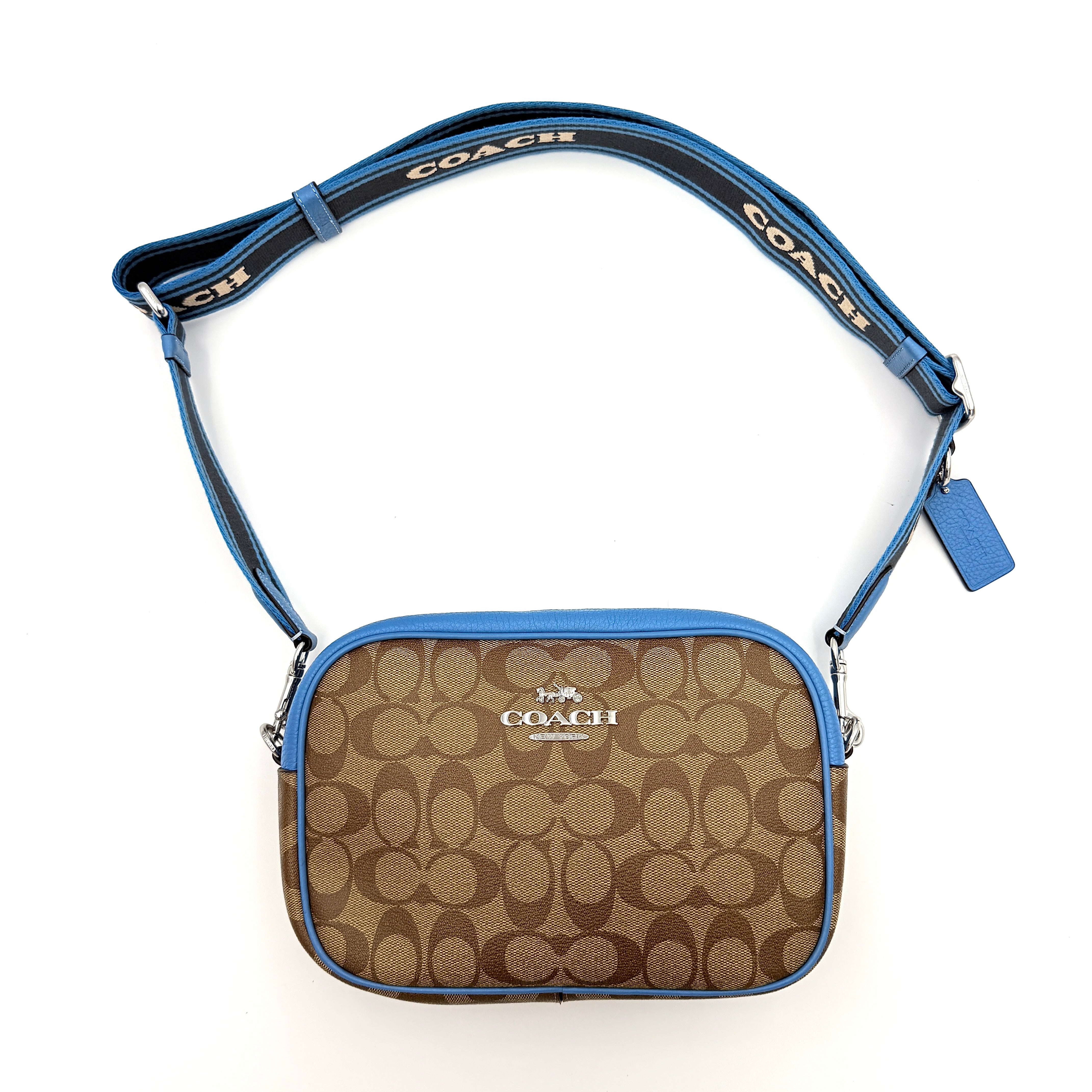 Coach Signature Jamie Crossbody Bag in beige and blue with bold logo webbing strap and blue leather trim, photographed against a white background.