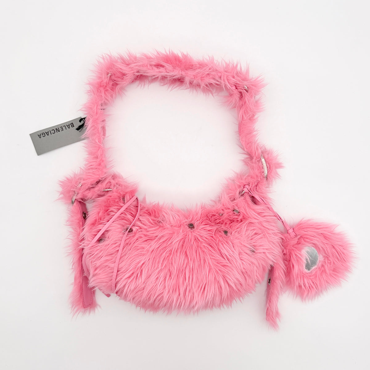 Balenciaga XS Le Cagole Shoulder Bag in sweet pink faux fur with heart-shaped mirror charm and silver hardware, styled on its original dust bag.