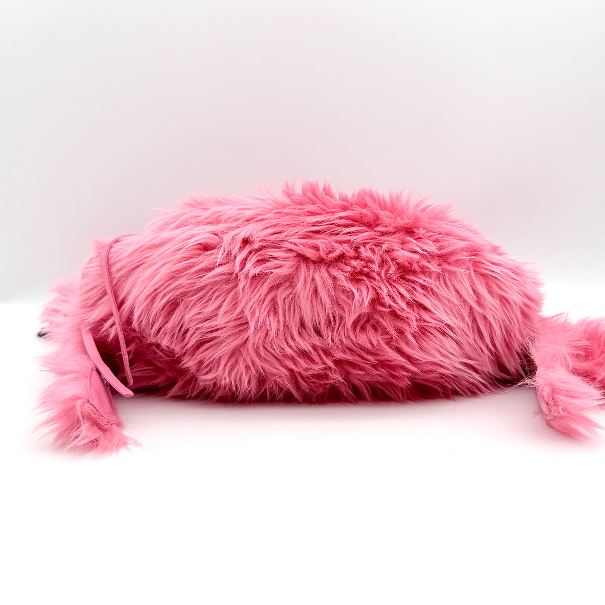 Balenciaga XS Le Cagole Shoulder Bag in sweet pink faux fur with heart-shaped mirror charm and silver hardware, styled on its original dust bag.
