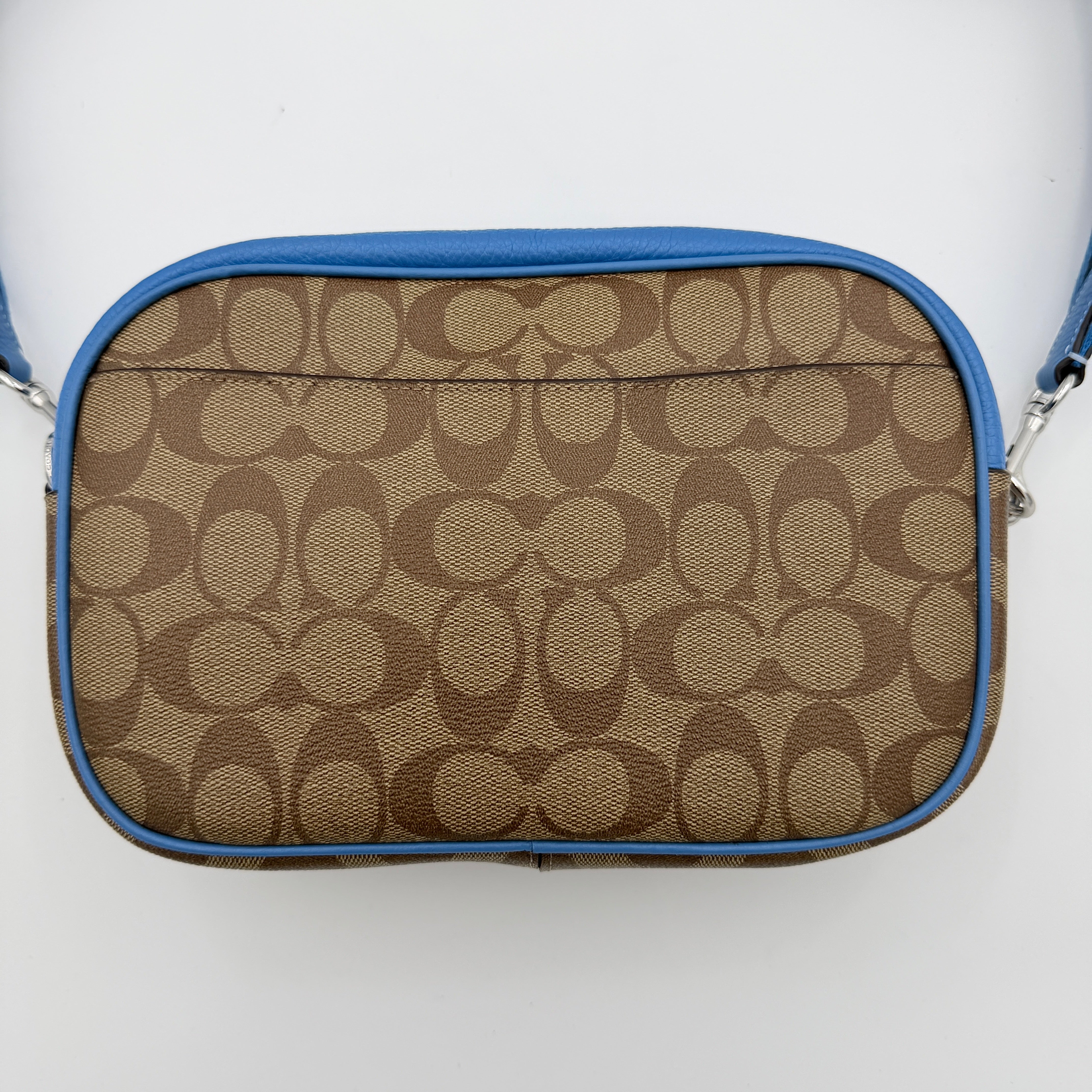 Coach Signature Jamie Crossbody Bag in beige and blue with bold logo webbing strap and blue leather trim, photographed against a white background.