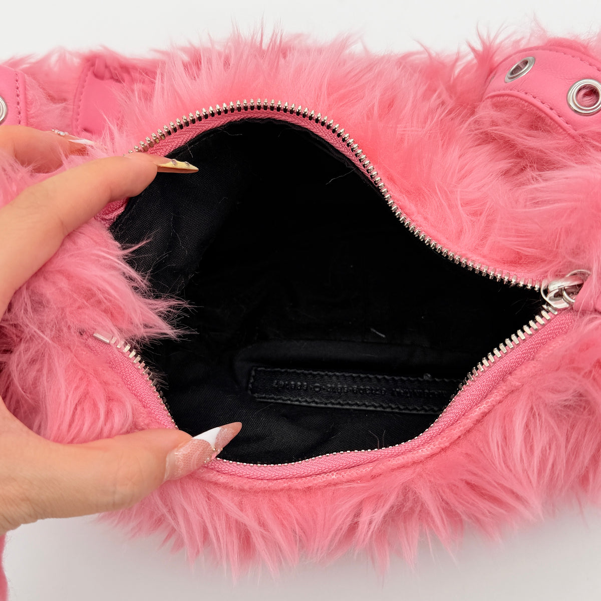 Balenciaga XS Le Cagole Shoulder Bag in sweet pink faux fur with heart-shaped mirror charm and silver hardware, styled on its original dust bag.