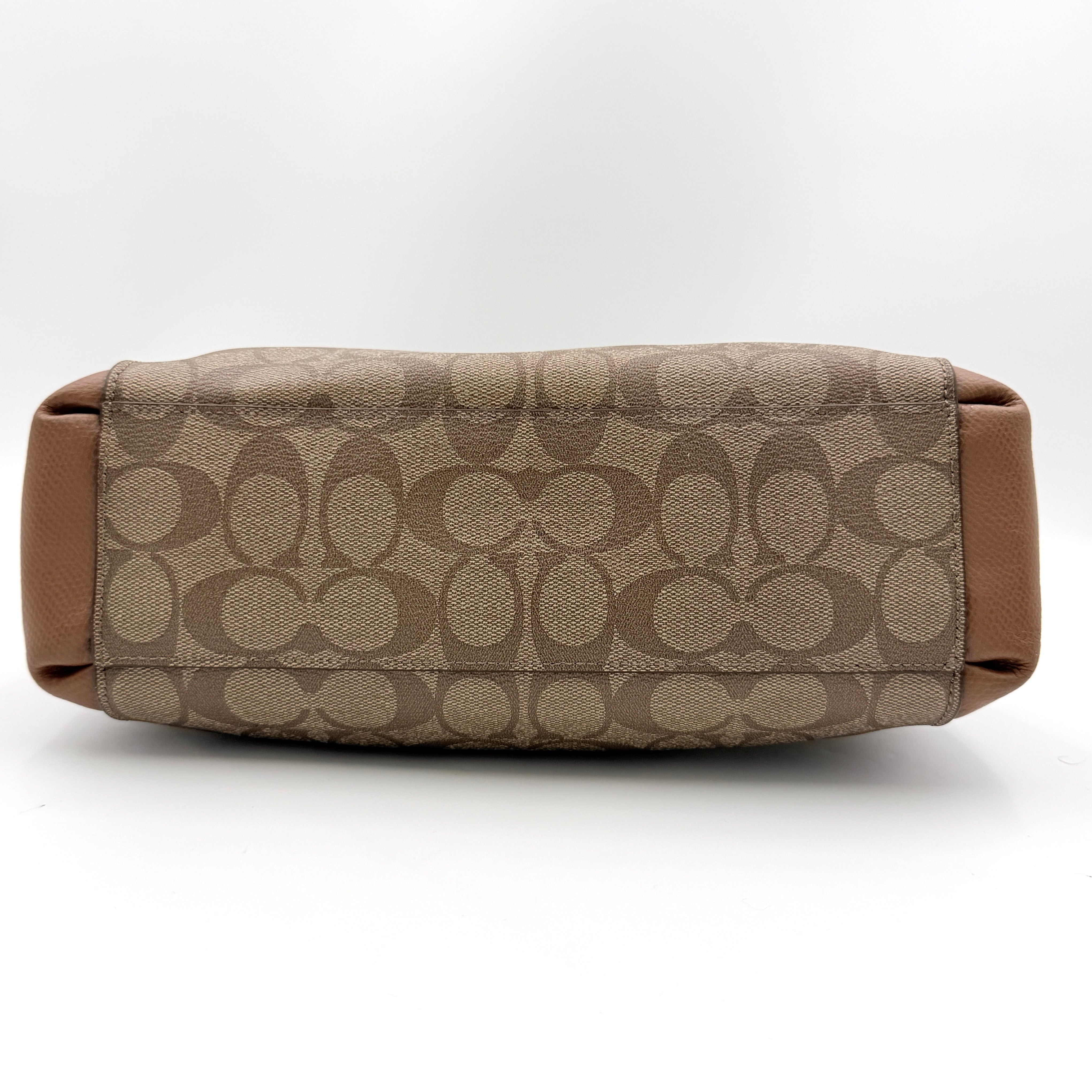 Coach Mini Christie Carryall in brown canvas and leather, shown with top handles and detachable strap.