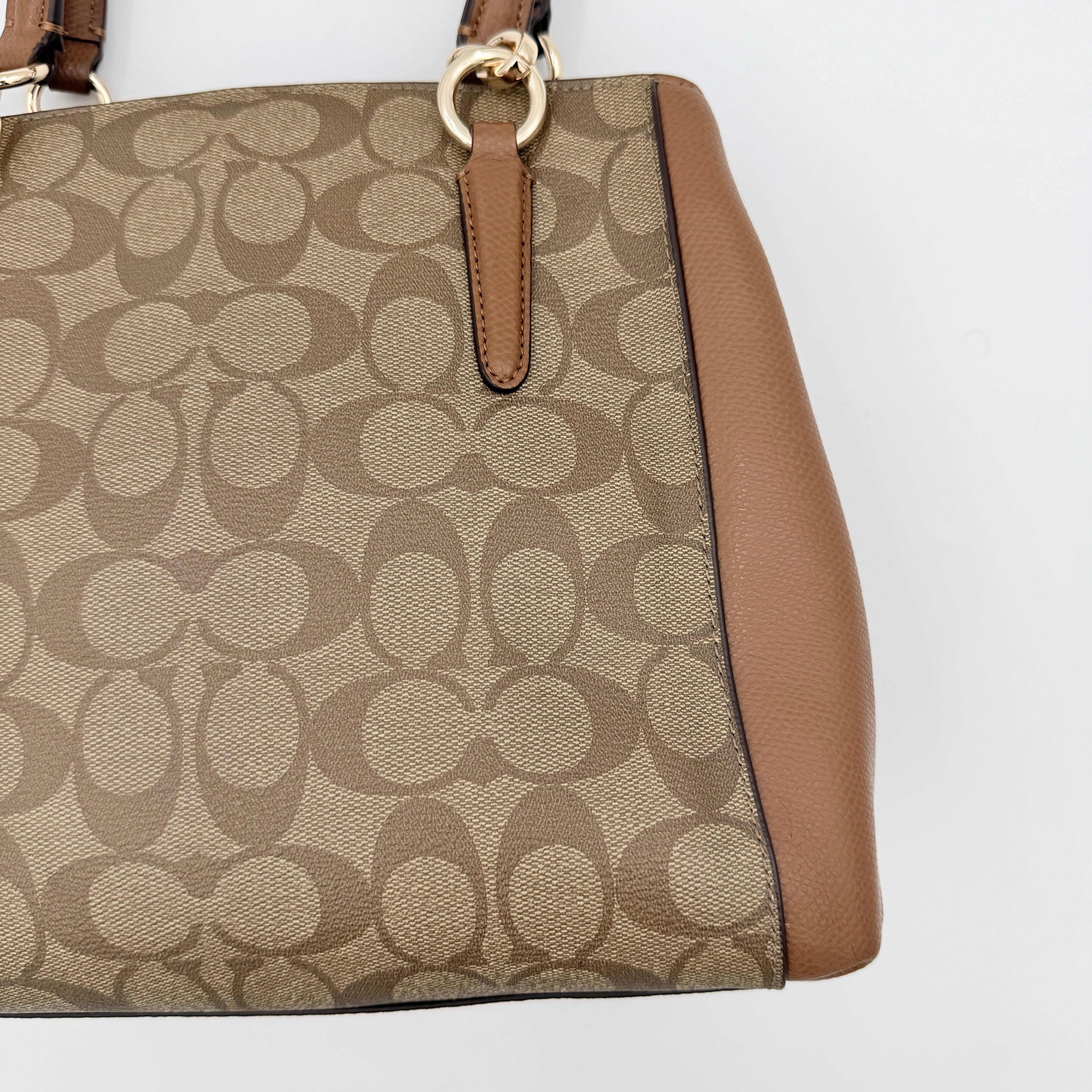 Coach Mini Christie Carryall in brown canvas and leather, shown with top handles and detachable strap.