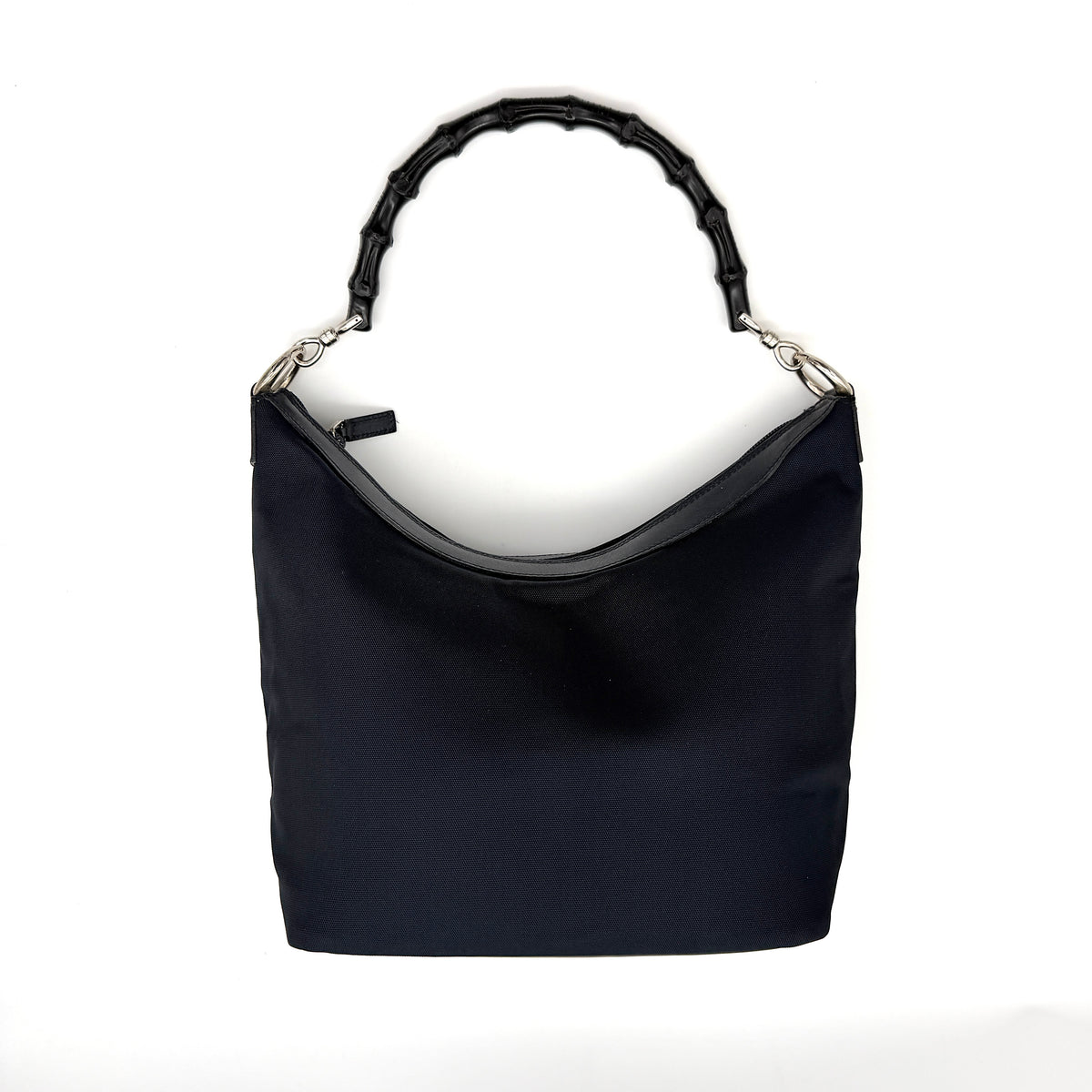 Gucci black nylon shoulder bag with bamboo handle and silver-tone hardware against a white background.