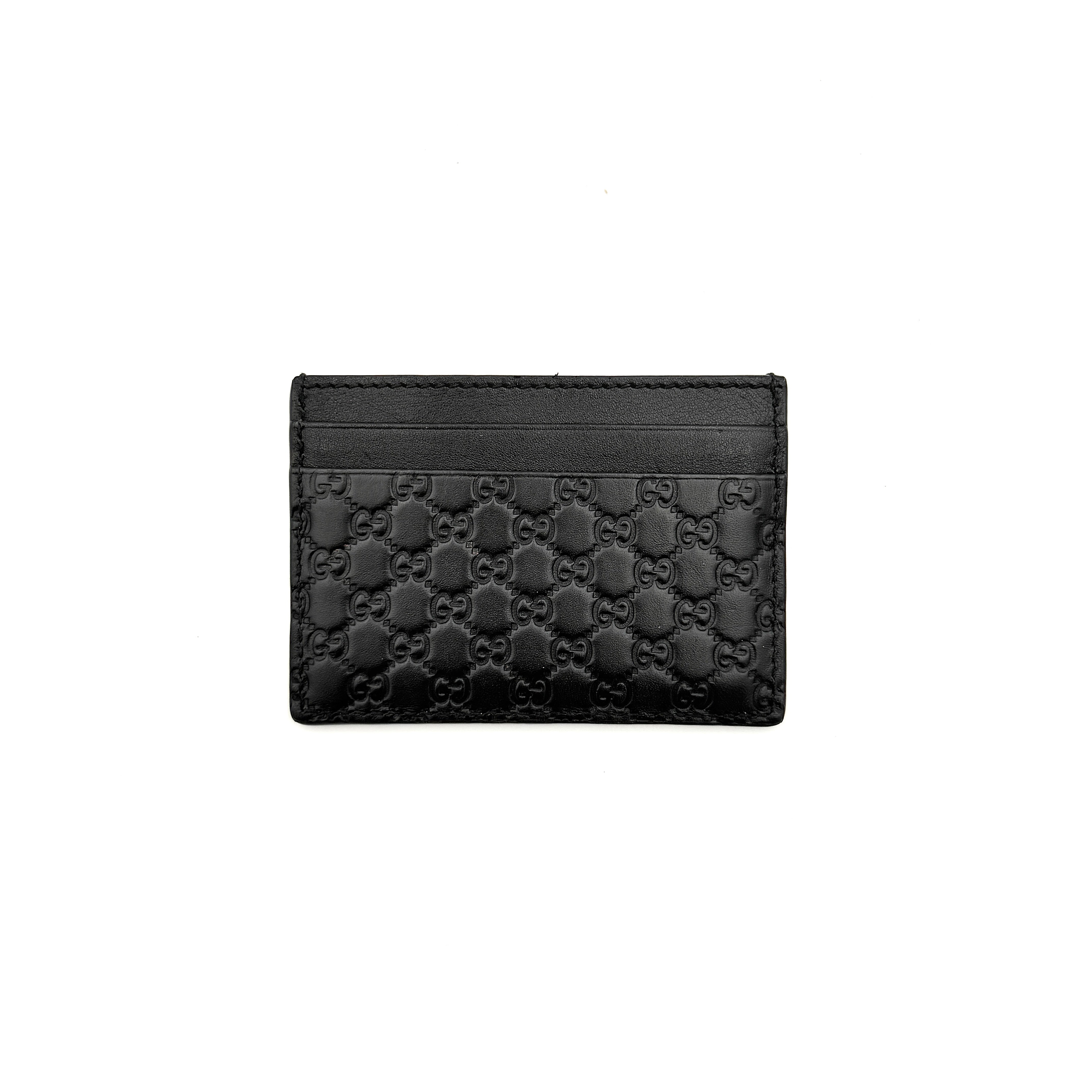Gucci GG Microguccissima card holder in black leather with embossed micro GG motif, compact silhouette and refined finish.