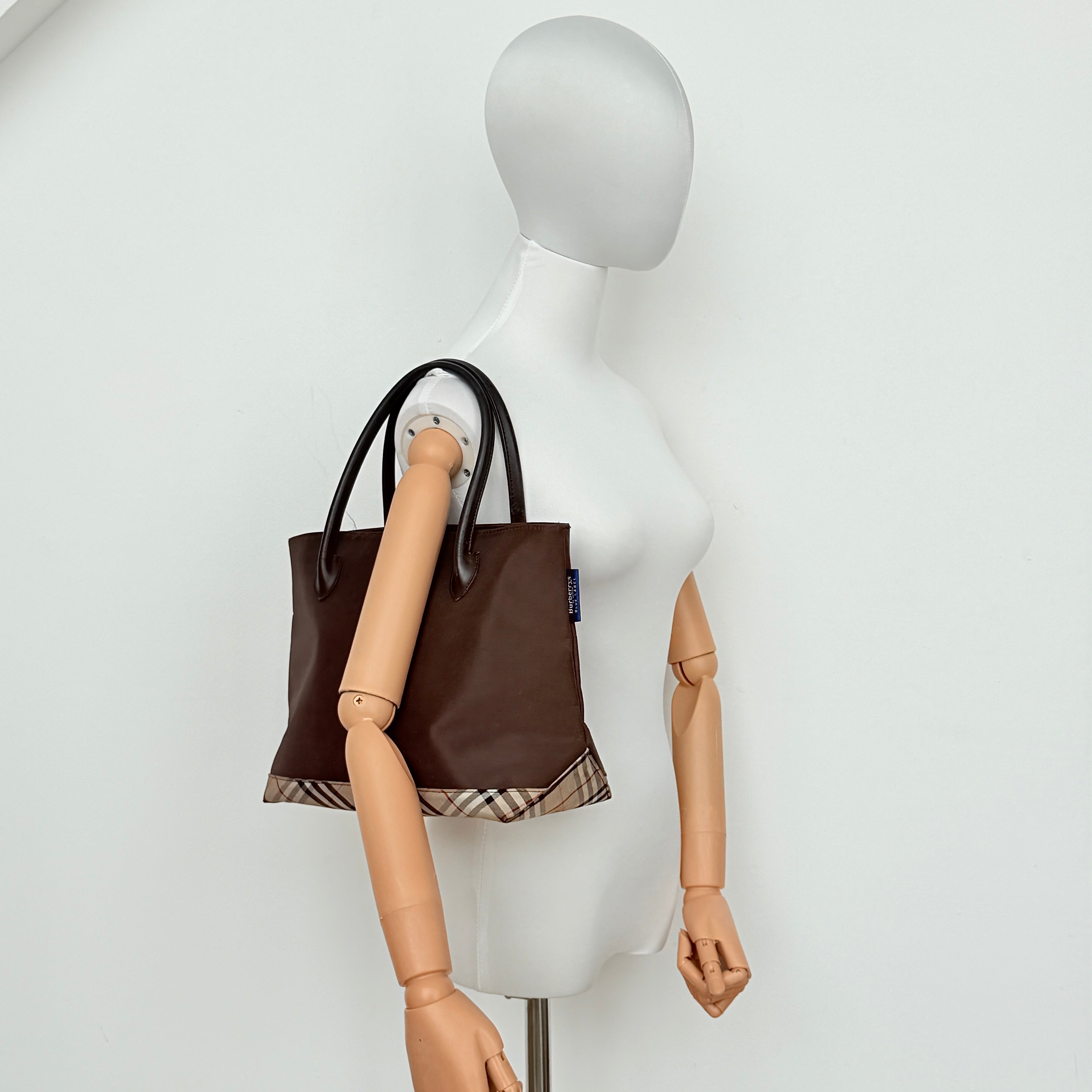 Burberry Blue Label nylon tote bag in brown with iconic check-detail base and structured double handles.