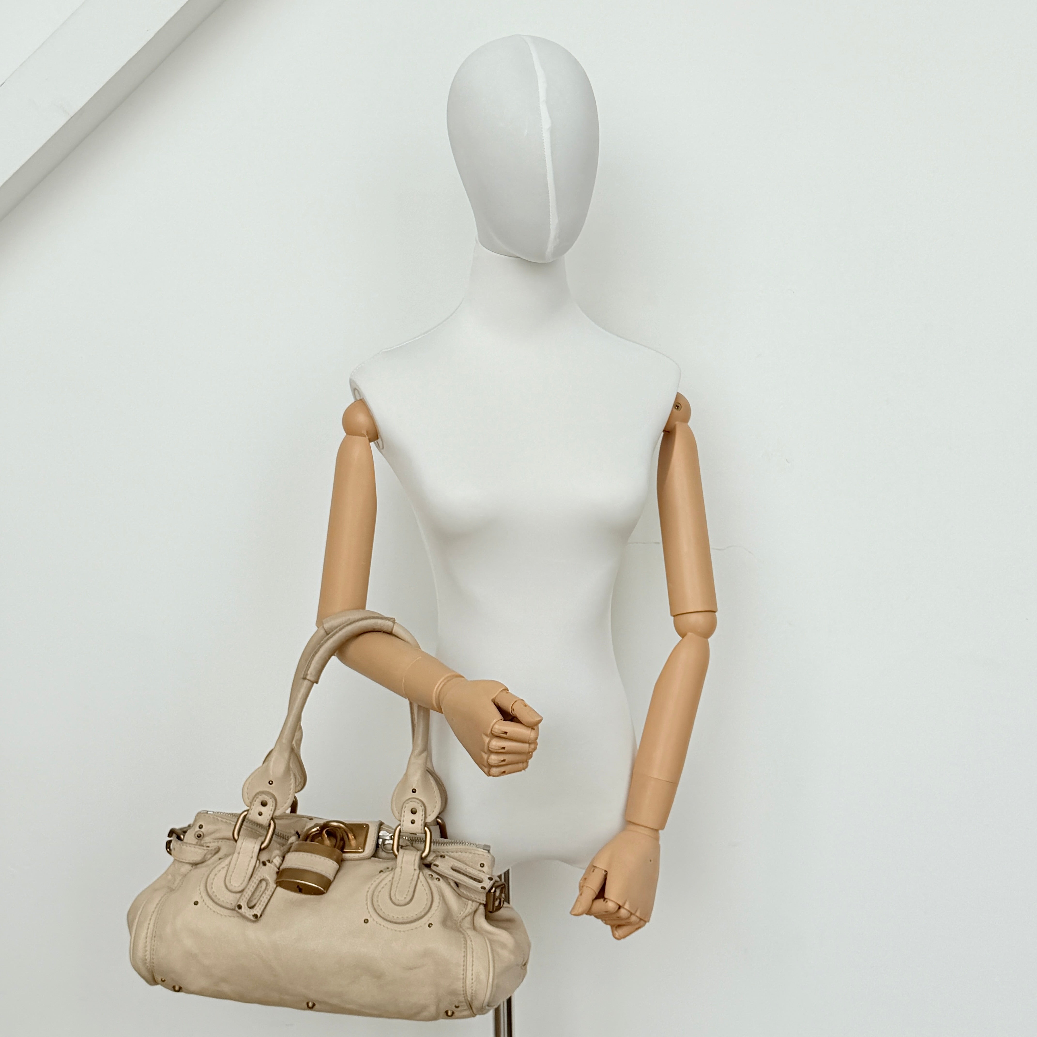 Chloé Paddington Shoulder Bag in ivory leather with signature brass padlock and double rolled handles.