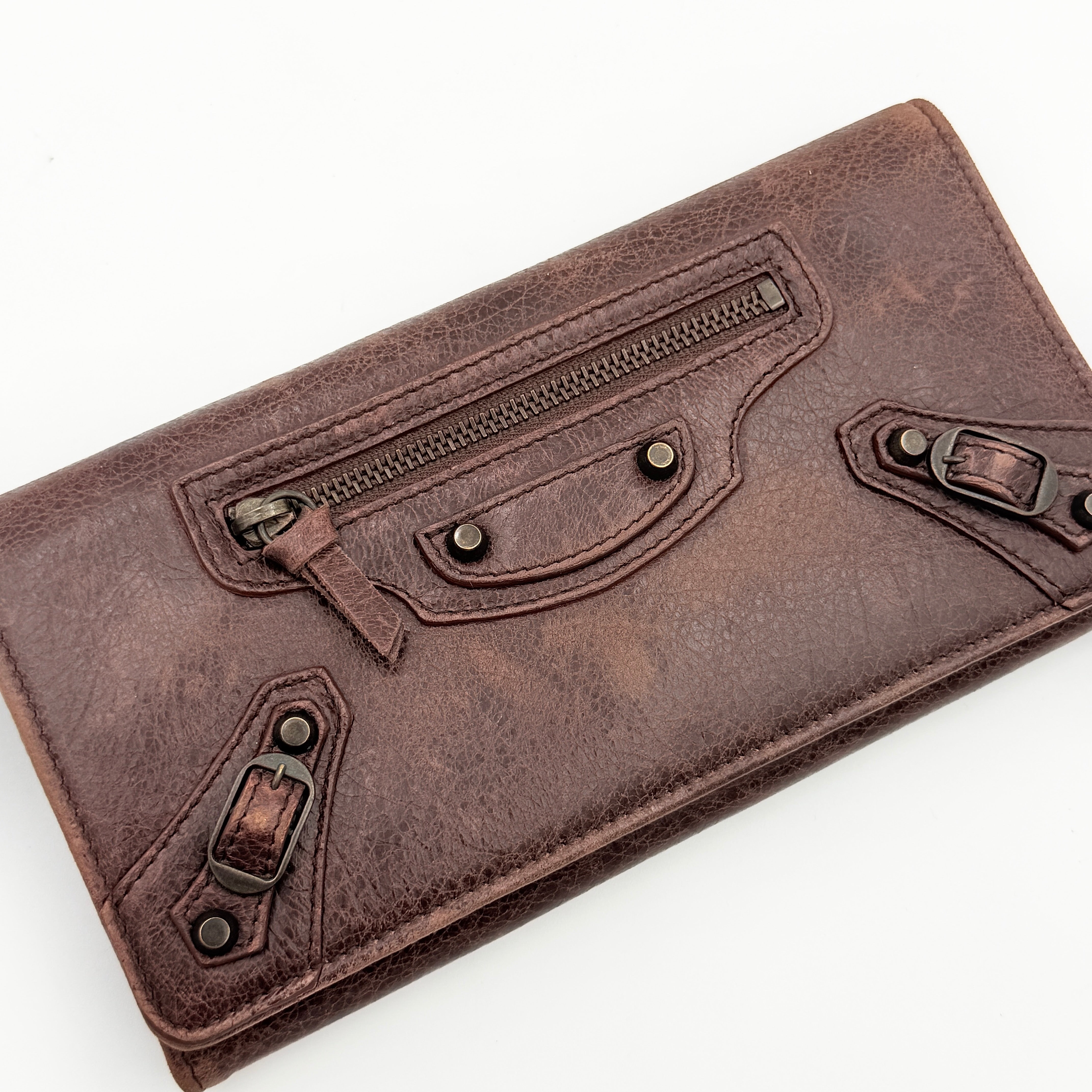 Balenciaga City Leather Long Wallet in brown distressed leather with signature buckle and zip detailing.