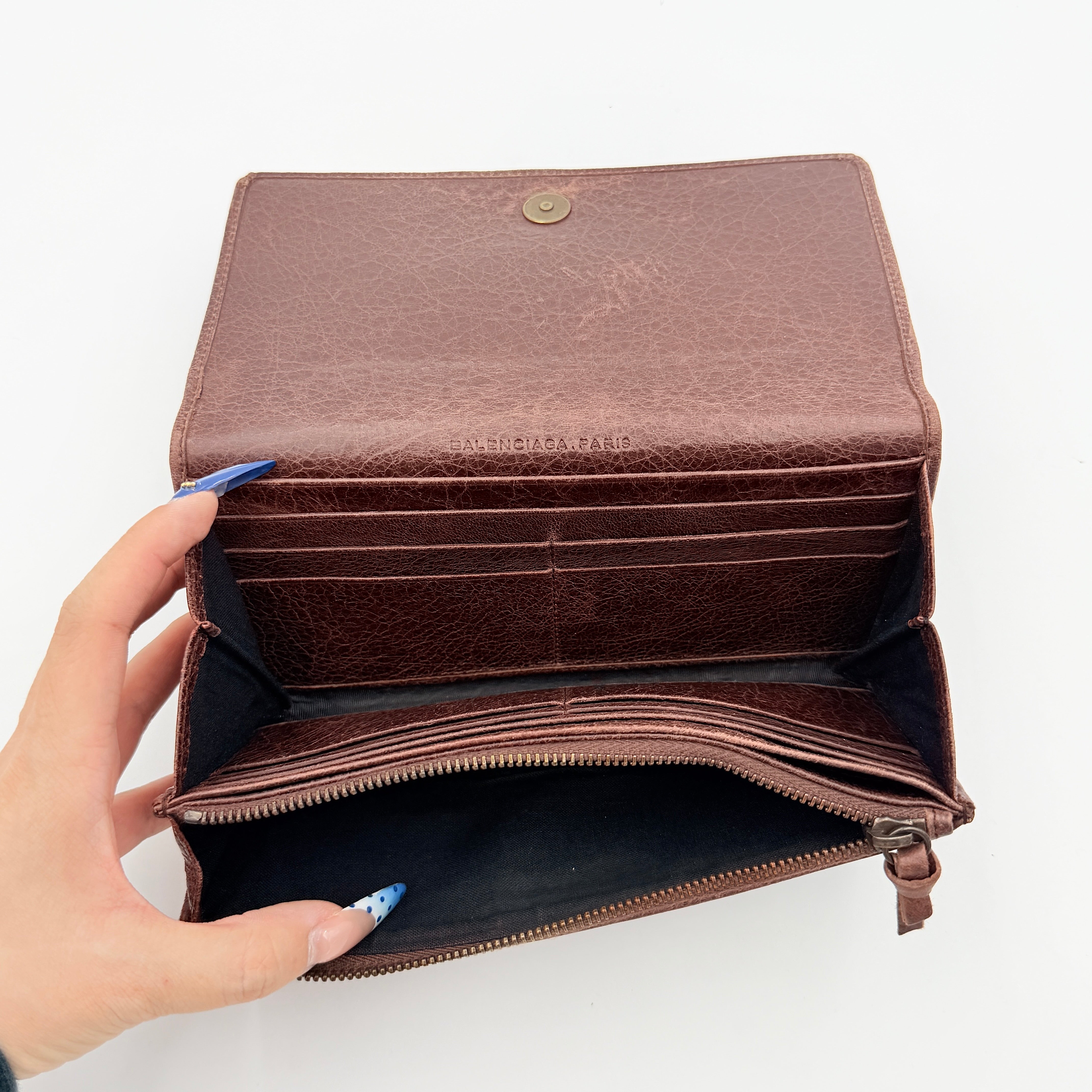 Balenciaga City Leather Long Wallet in brown distressed leather with signature buckle and zip detailing.