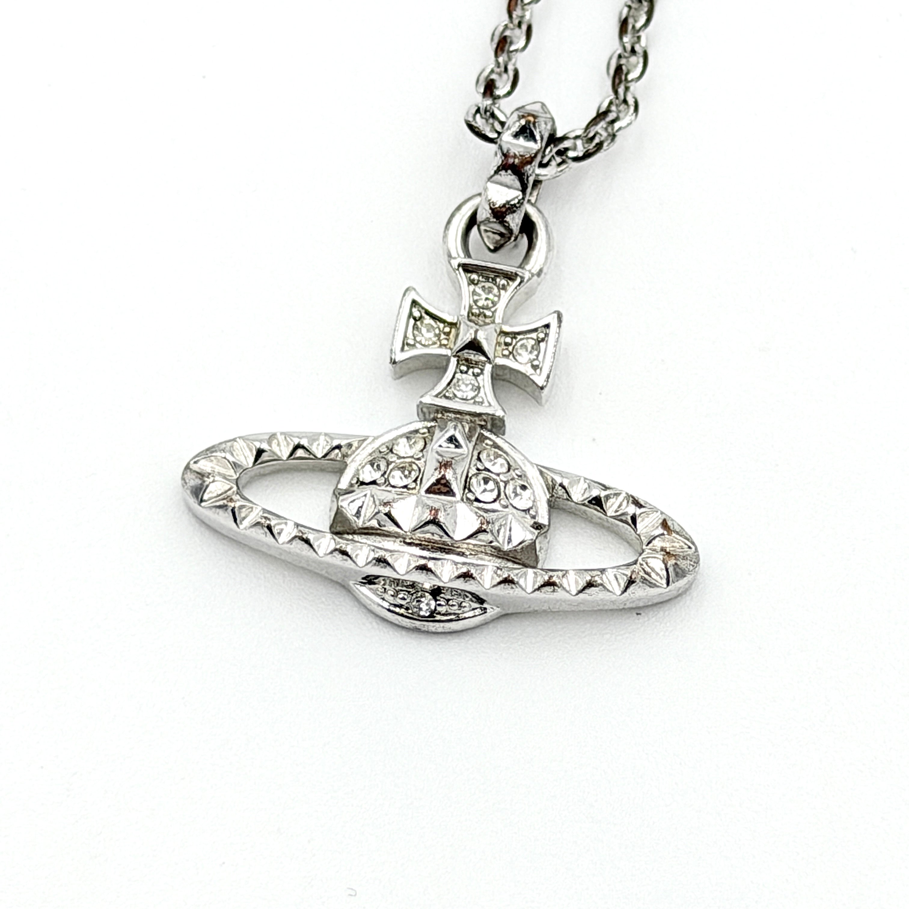 Vivienne Westwood silver orb necklace with crystal-studded Saturn motif on a textured chain, displayed against a clean background.
