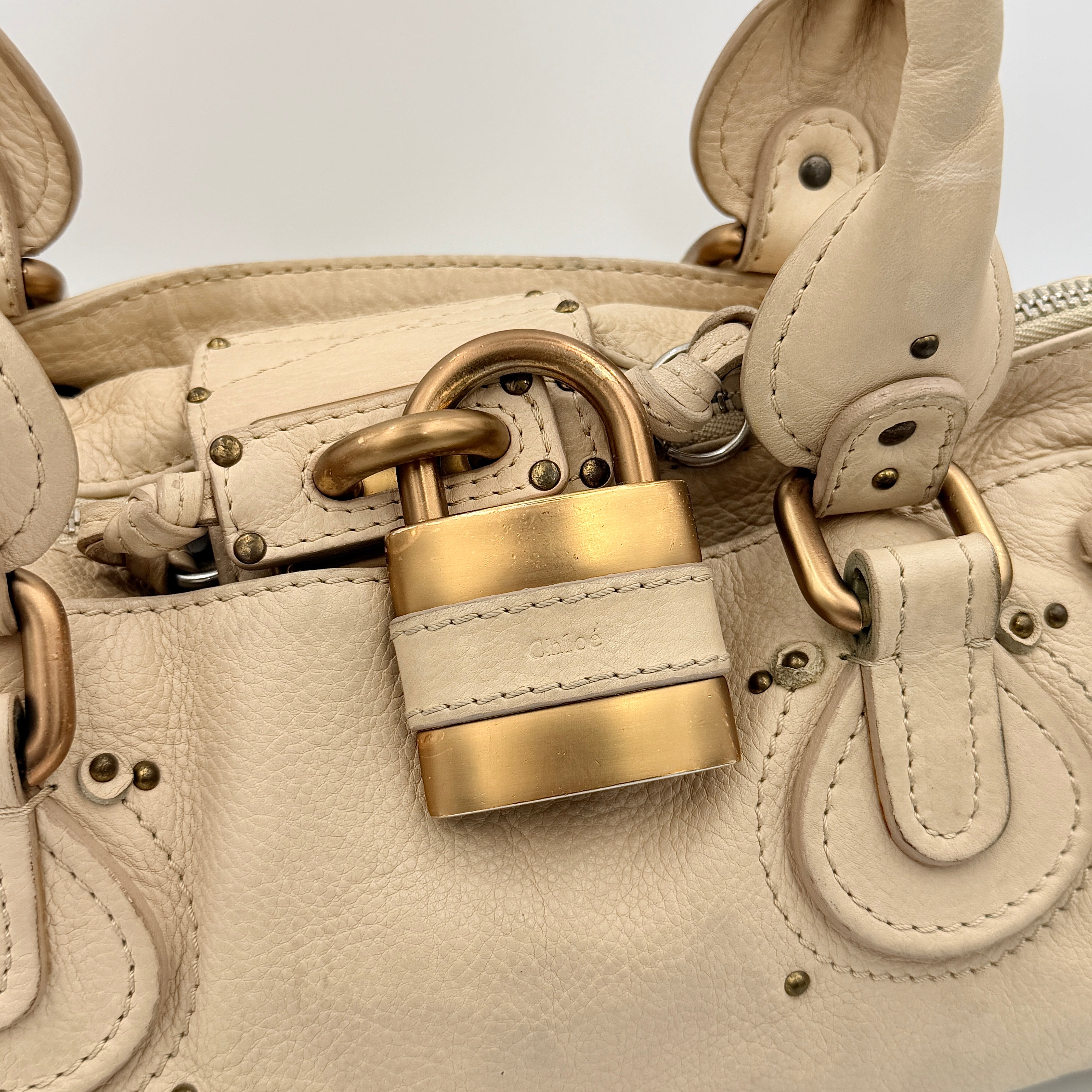 Chloé Paddington Shoulder Bag in ivory leather with signature brass padlock and double rolled handles.