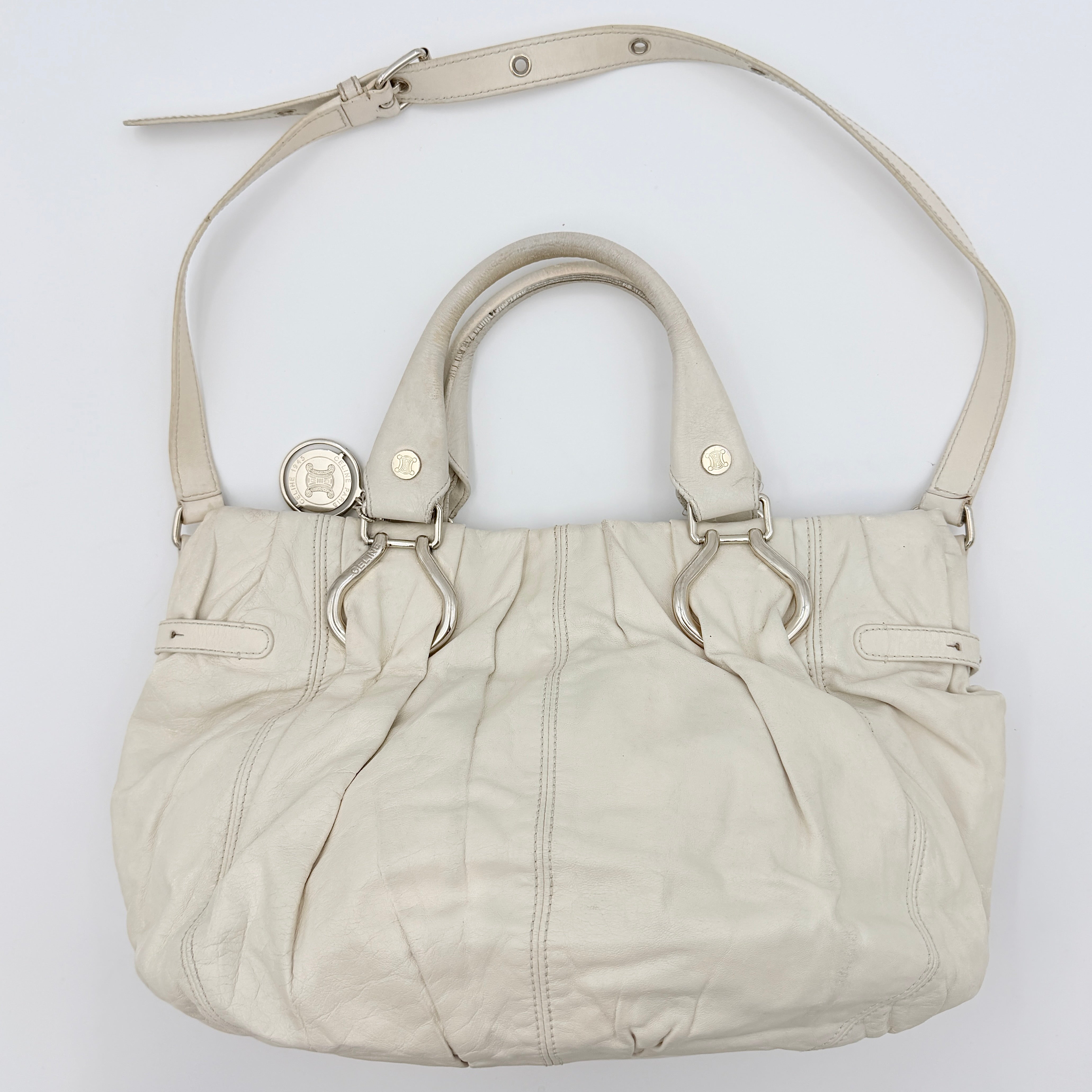 Celine 2Way Leather Shoulder Bag in white leather with architectural silver hardware, top handles, and an adjustable shoulder strap.