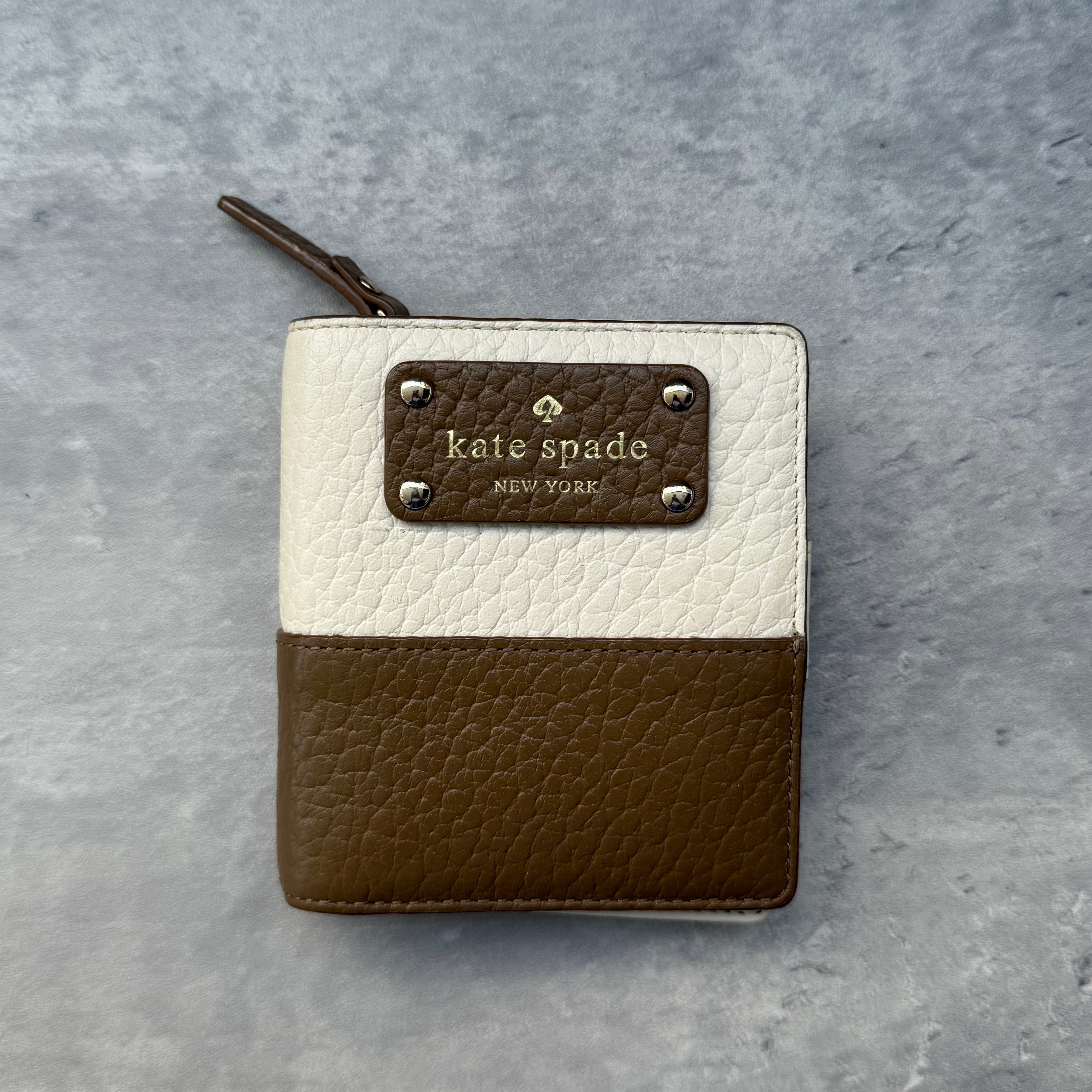 Kate Spade Mini Wallet Brown/White, crafted from pebbled leather with logo plaque, card slots, zip coin pocket, and billfold interior.