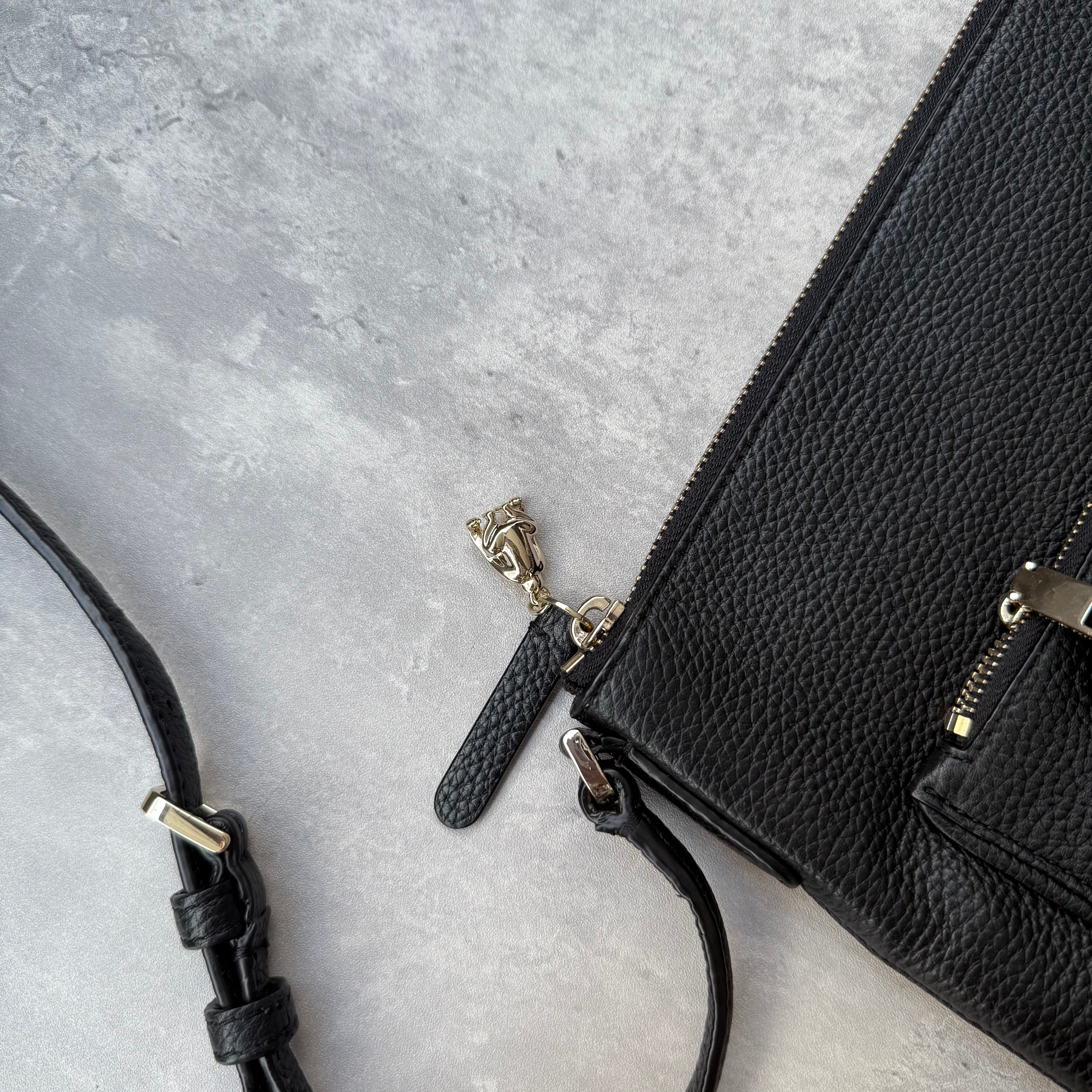 Kate Spade New York black pebbled leather crossbody bag with tassel zip pocket and gold-tone hardware