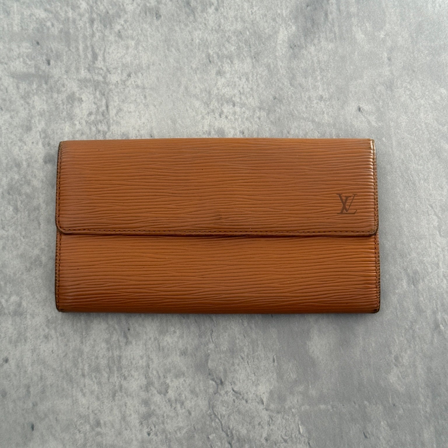 Louis Vuitton Cipango Gold Epi Leather Flap Continental Wallet in a discontinued warm golden hue, crafted from textured Epi leather with an embossed LV logo and multiple compartments.