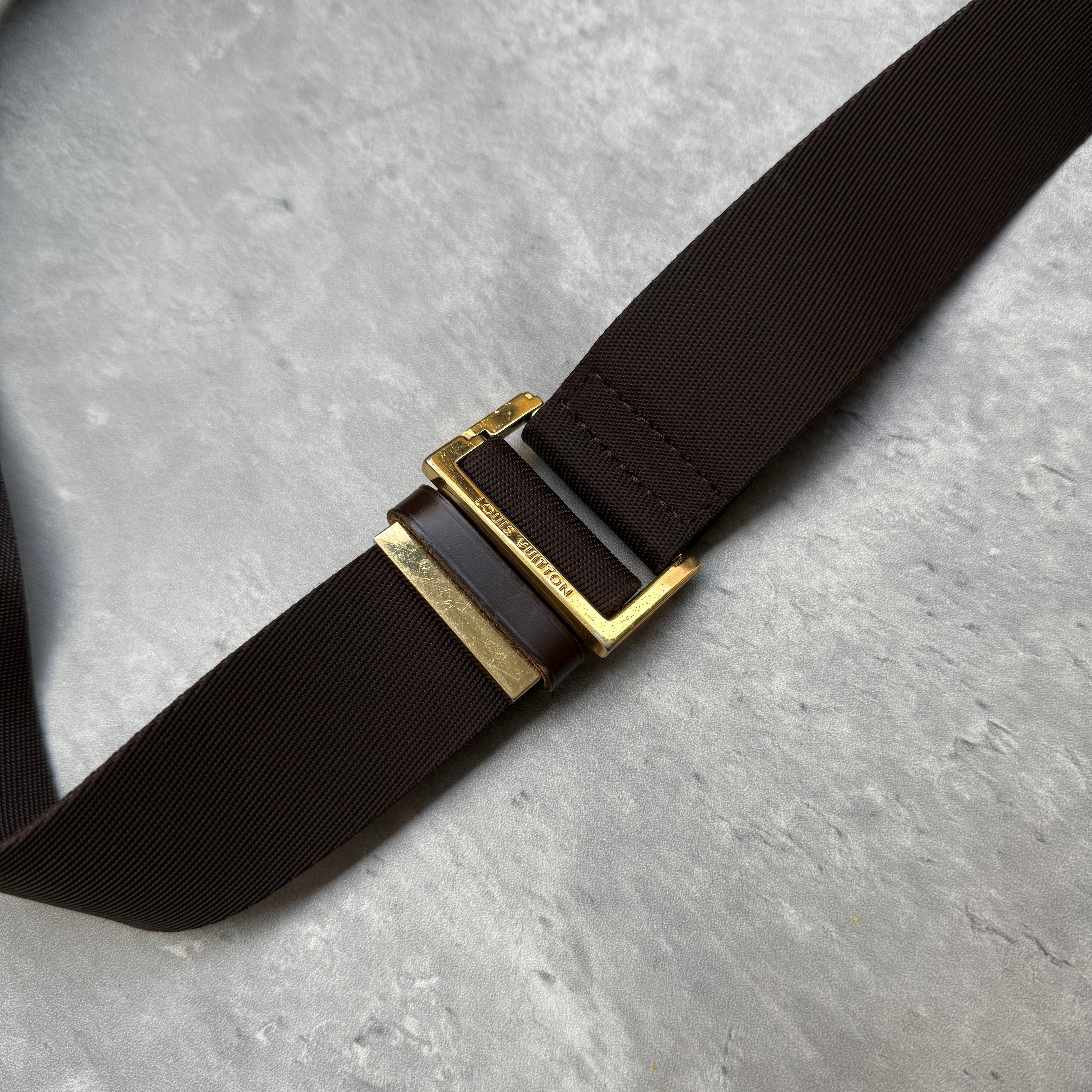 Louis Vuitton Geronimos Bag in brown Damier Ebene canvas with adjustable strap, red interior, and zip closure.