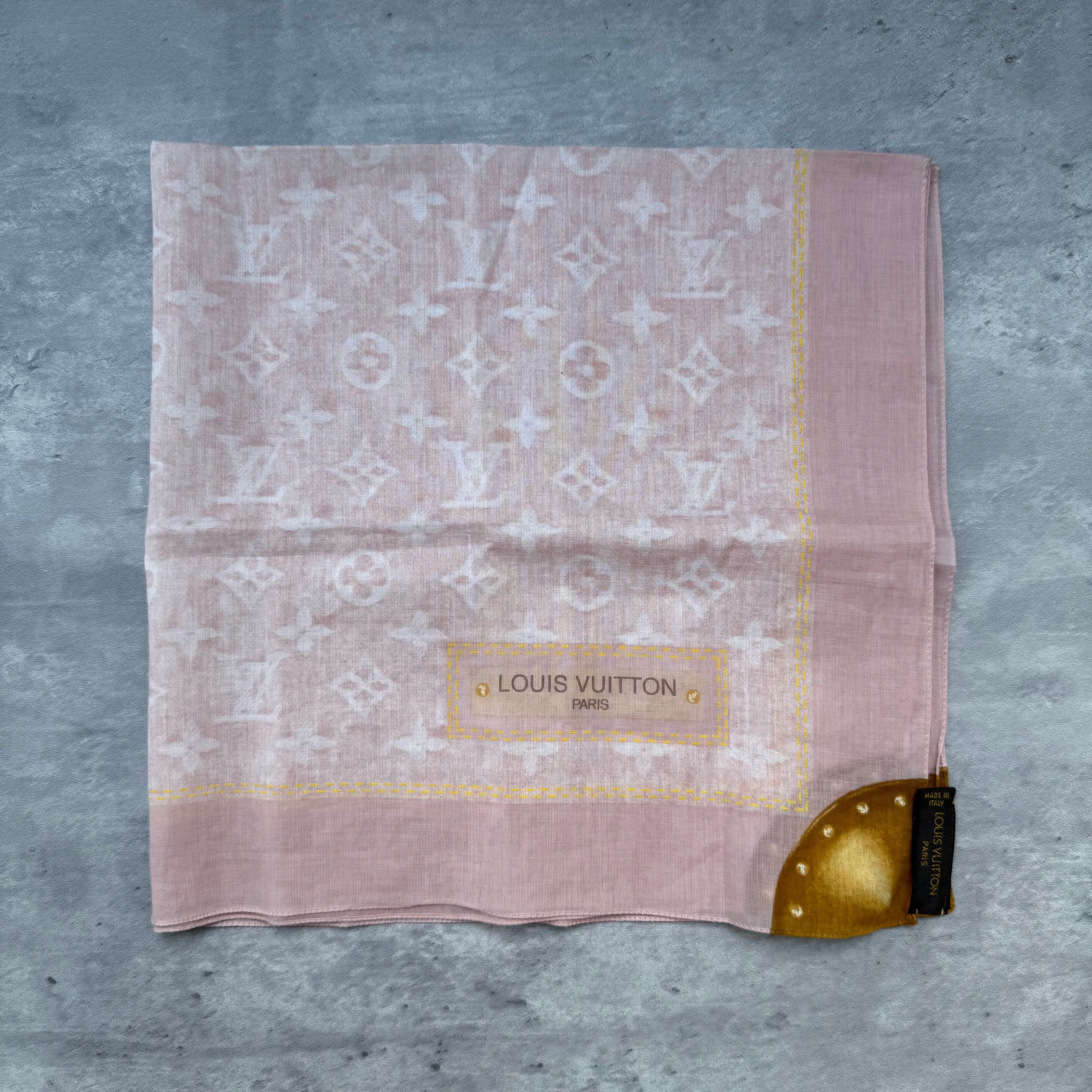 Louis Vuitton Monogram Denim Silk Scarf in light pink with gold accent detail, featuring iconic LV pattern.