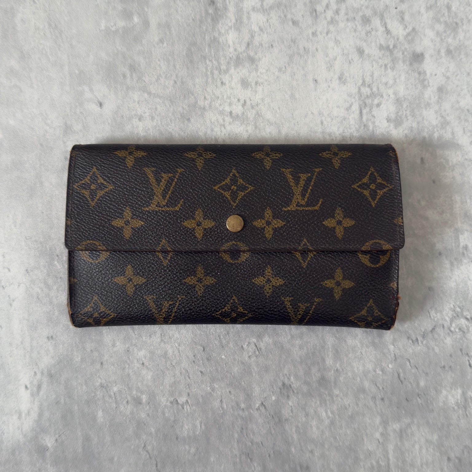 Luxurious Louis Vuitton Monogram Portefeuille Sarah Long Wallet, showcasing the iconic LV print and a spacious, organized interior, perfect for everyday sophistication.