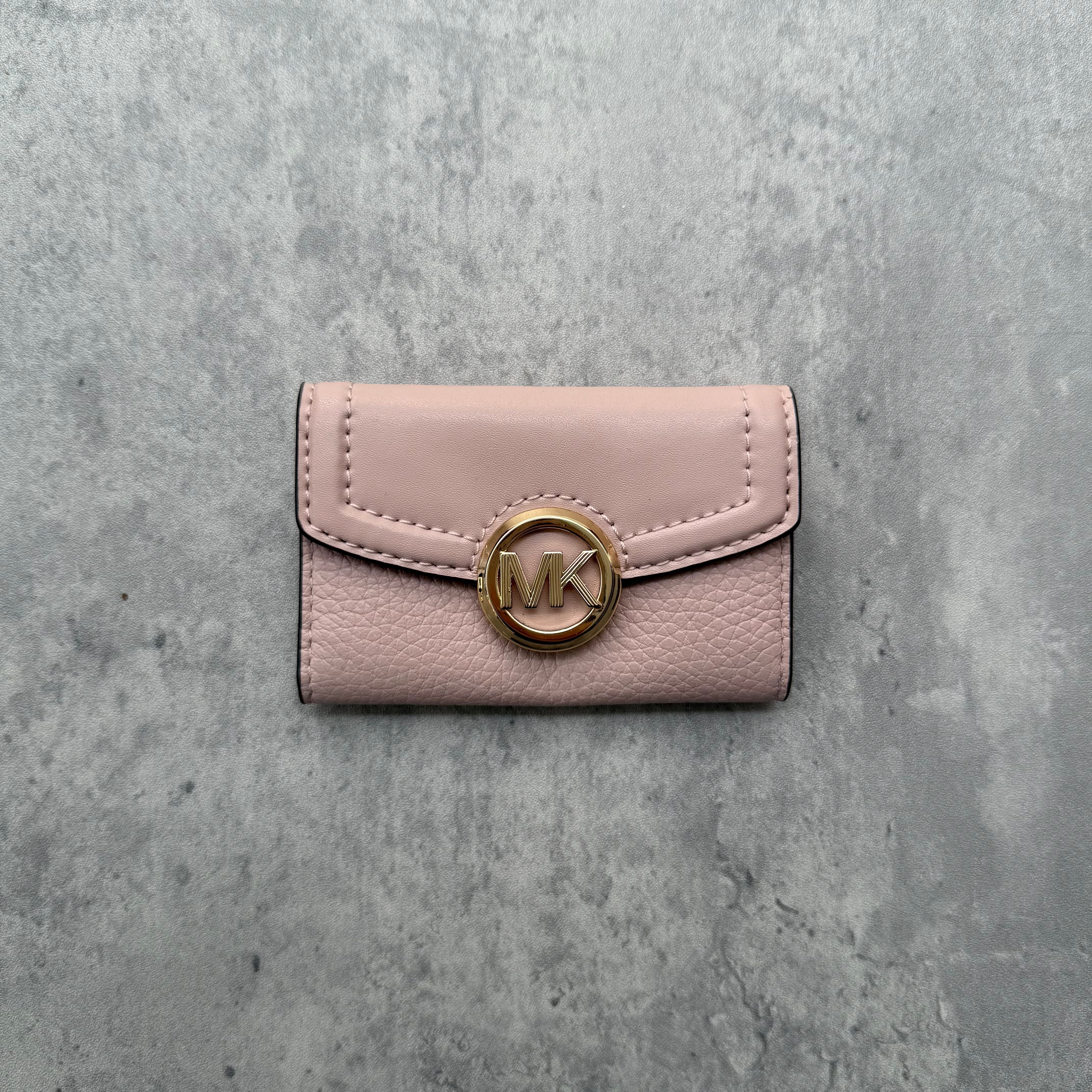 Michael Kors Pink Key Holder in pebbled leather with gold MK logo snap closure and interior key hooks.