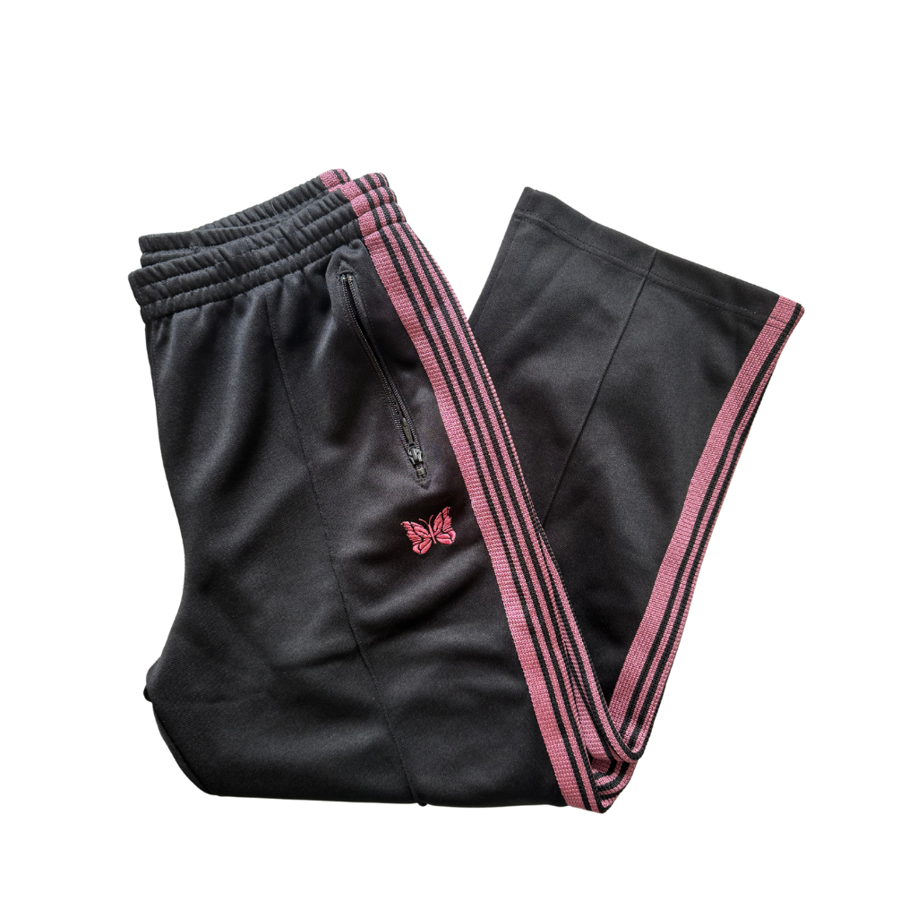 Needles Track Pants Black and Pink, featuring pink taping and butterfly embroidery with zippered pockets.