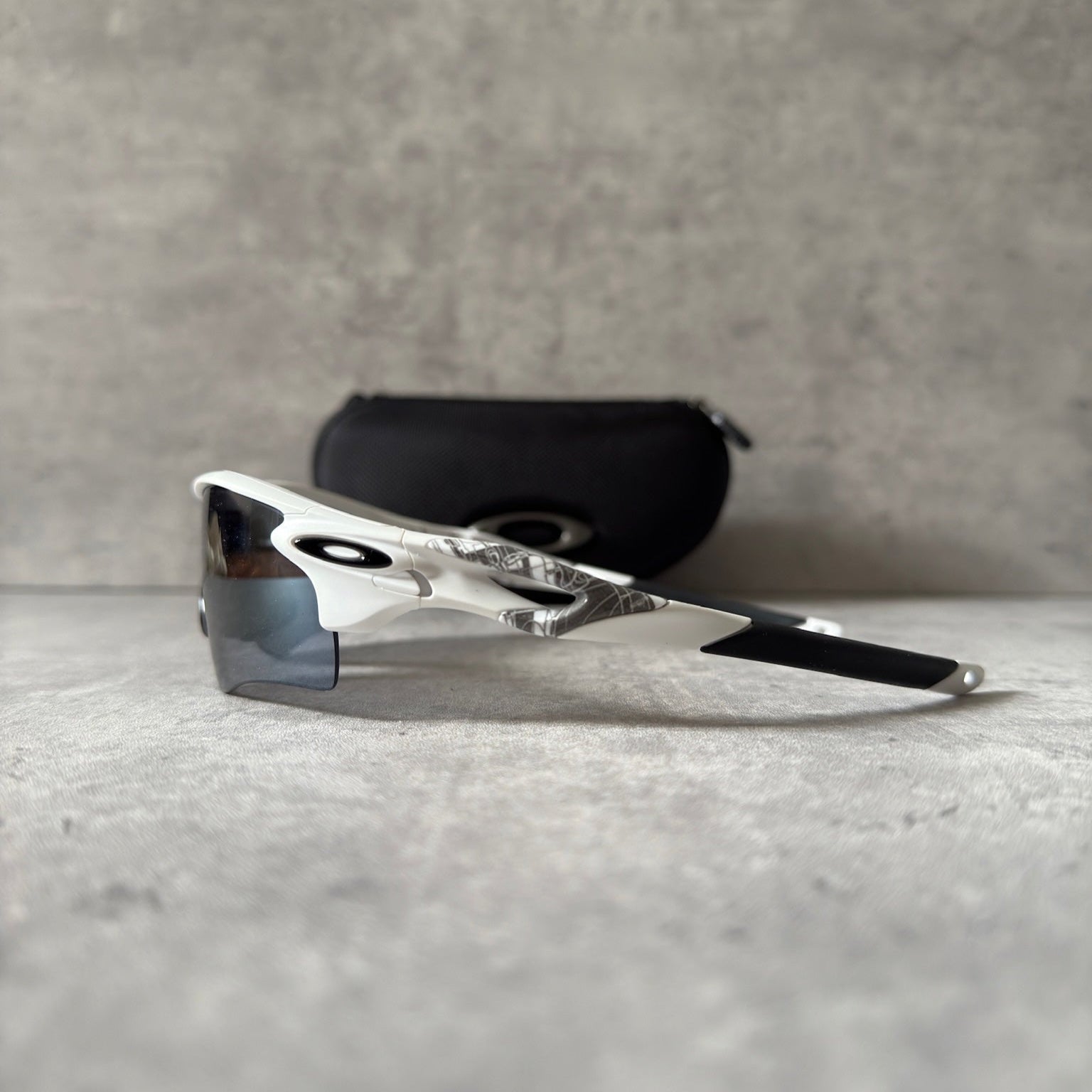 Oakley Prizm Radarlock Path sunglasses with white frame and Prizm lenses, showcasing advanced color and contrast enhancement technology for superior clarity in sports performance.